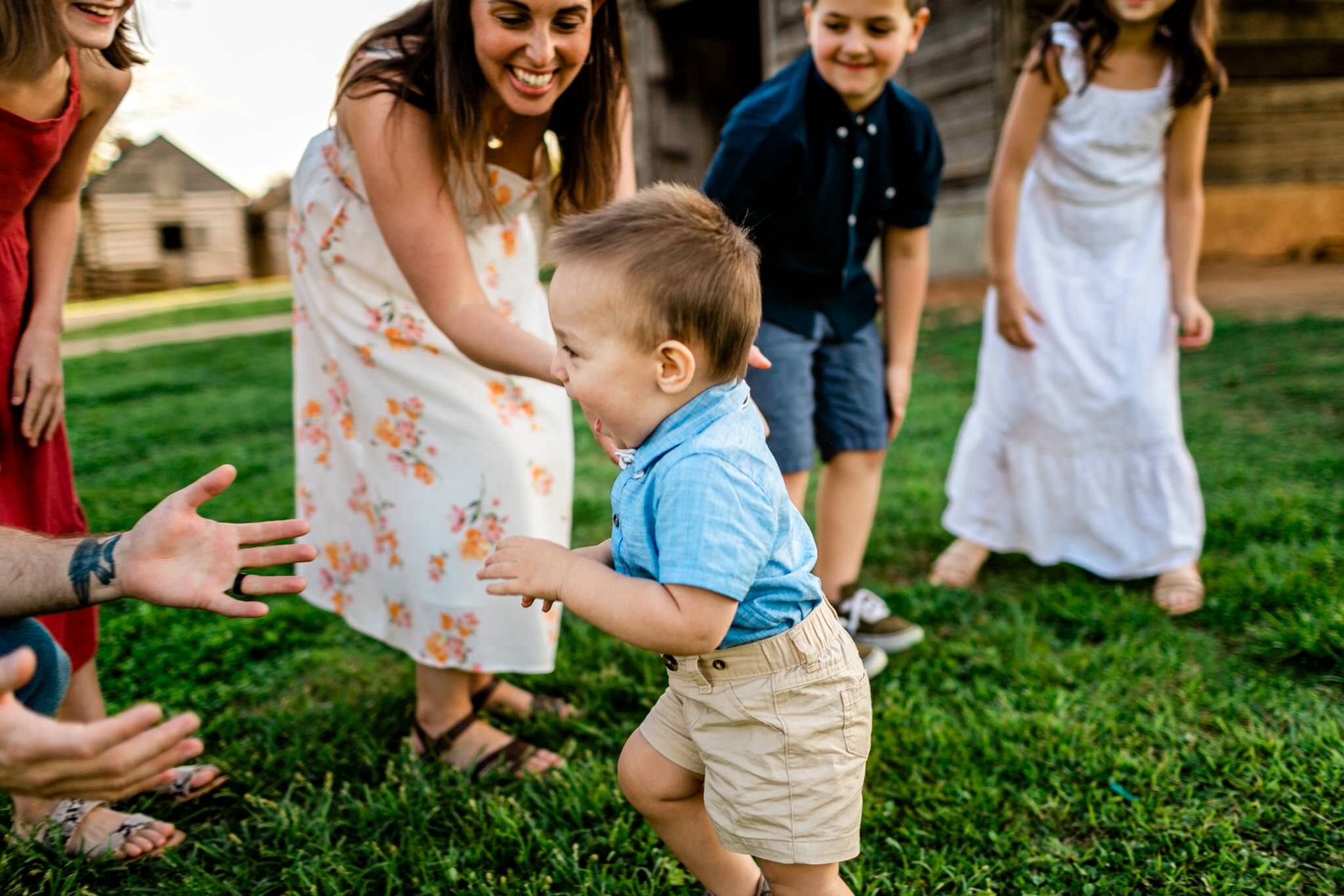 Raleigh Family Photographer | Joyner Park | By G. Lin Photography | Young boy running to dad