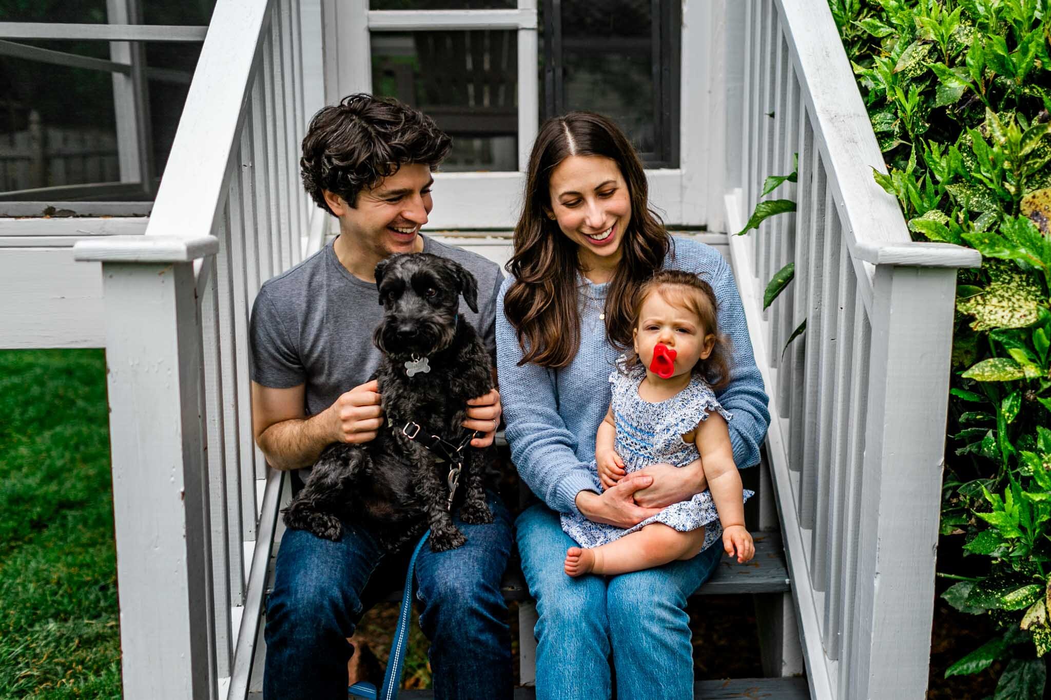 Durham Family Photographer | By G. Lin Photography | Parent sitting with baby and dog on back porch