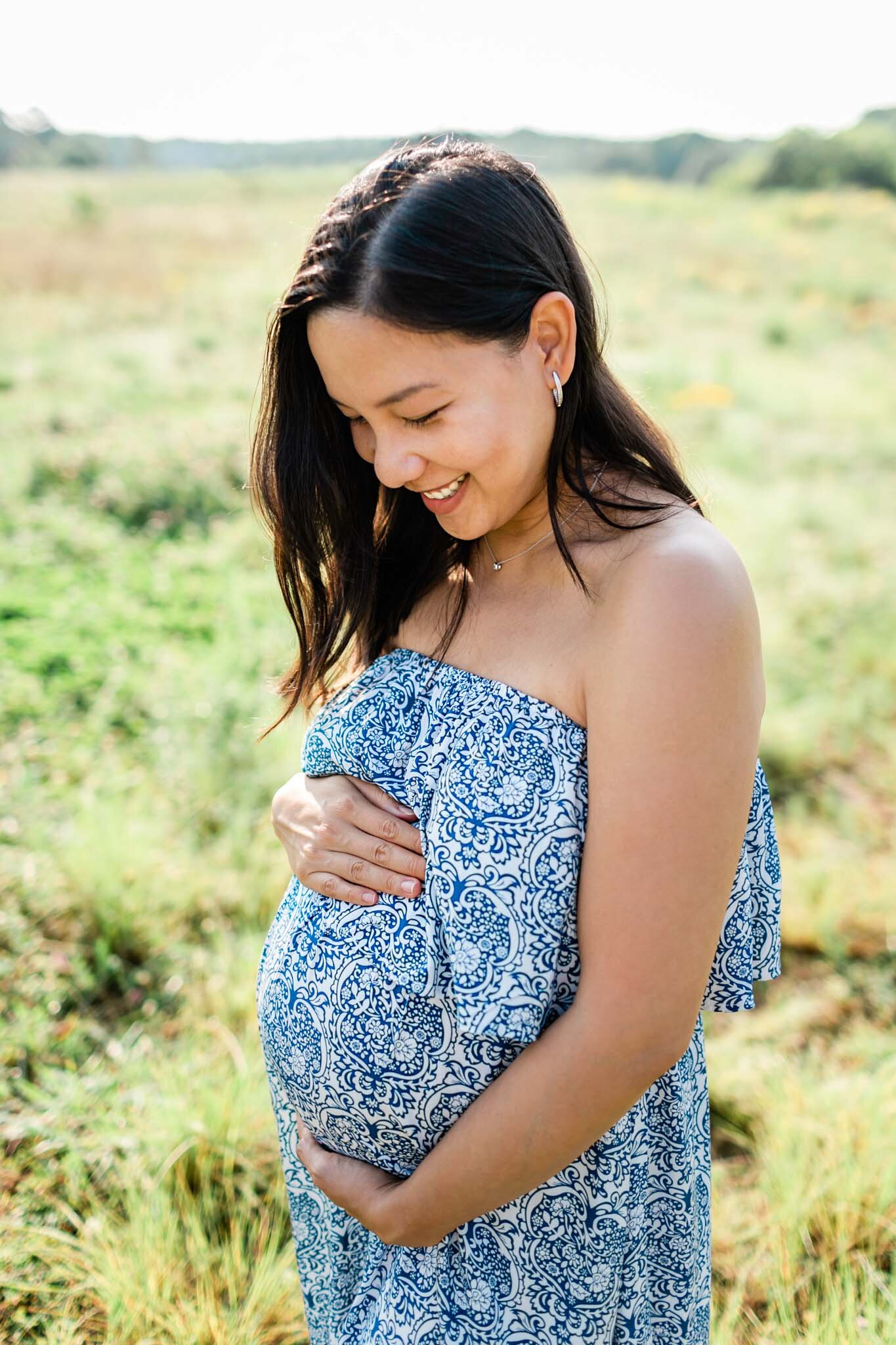 Raleigh Maternity Photographer | By G. Lin Photography | NCMA Maternity Photos | Pregnant woman smiling and standing in open field
