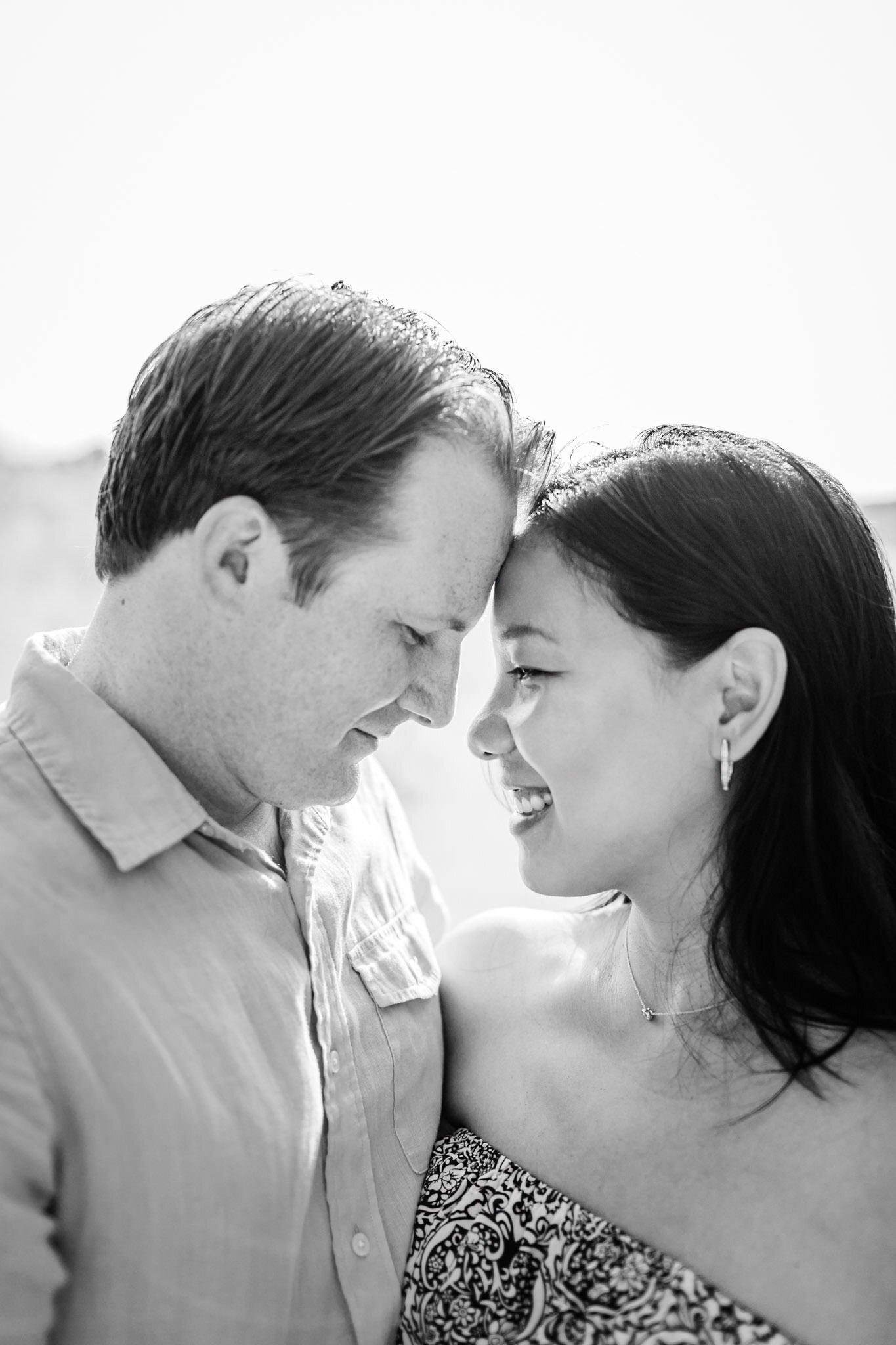 Raleigh Maternity Photographer | By G. Lin Photography | NCMA Maternity Photos | Beautiful black and white image of man and woman leaning heads towards one another