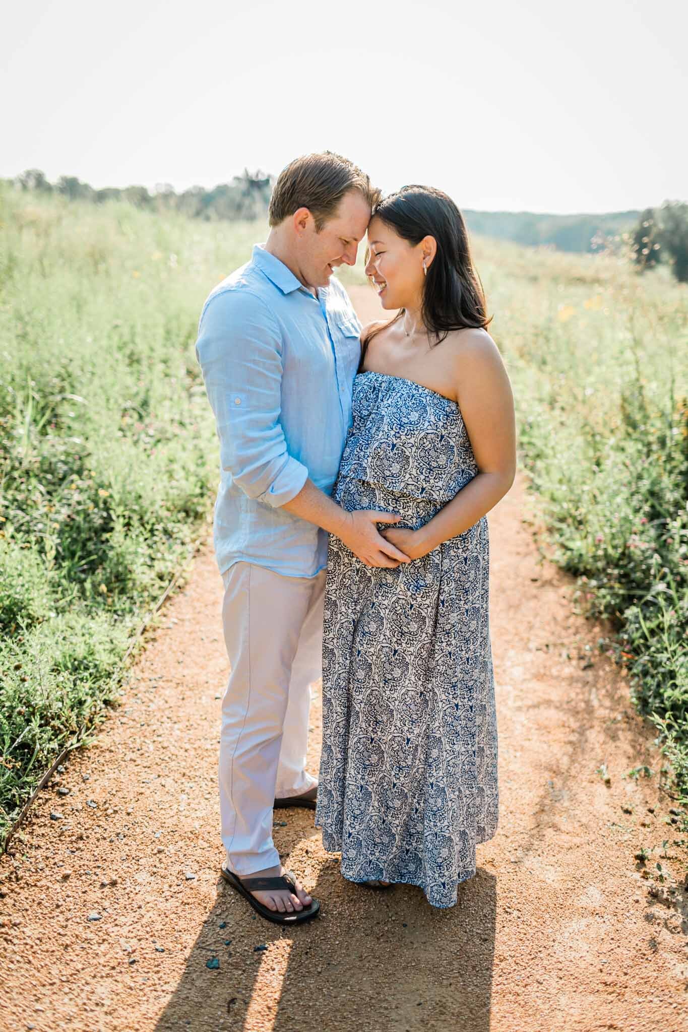 Raleigh Maternity Photographer | By G. Lin Photography | NCMA Maternity Photos | Bright summer photo of man and woman standing on pathway