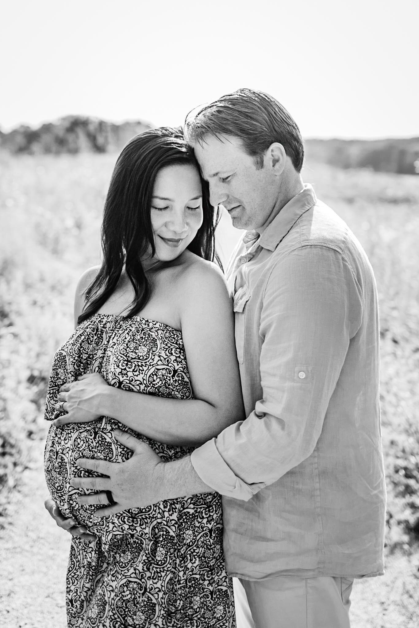 Raleigh Maternity Photographer | By G. Lin Photography | NCMA Maternity Photos | Black and white photo of couple embracing baby bump