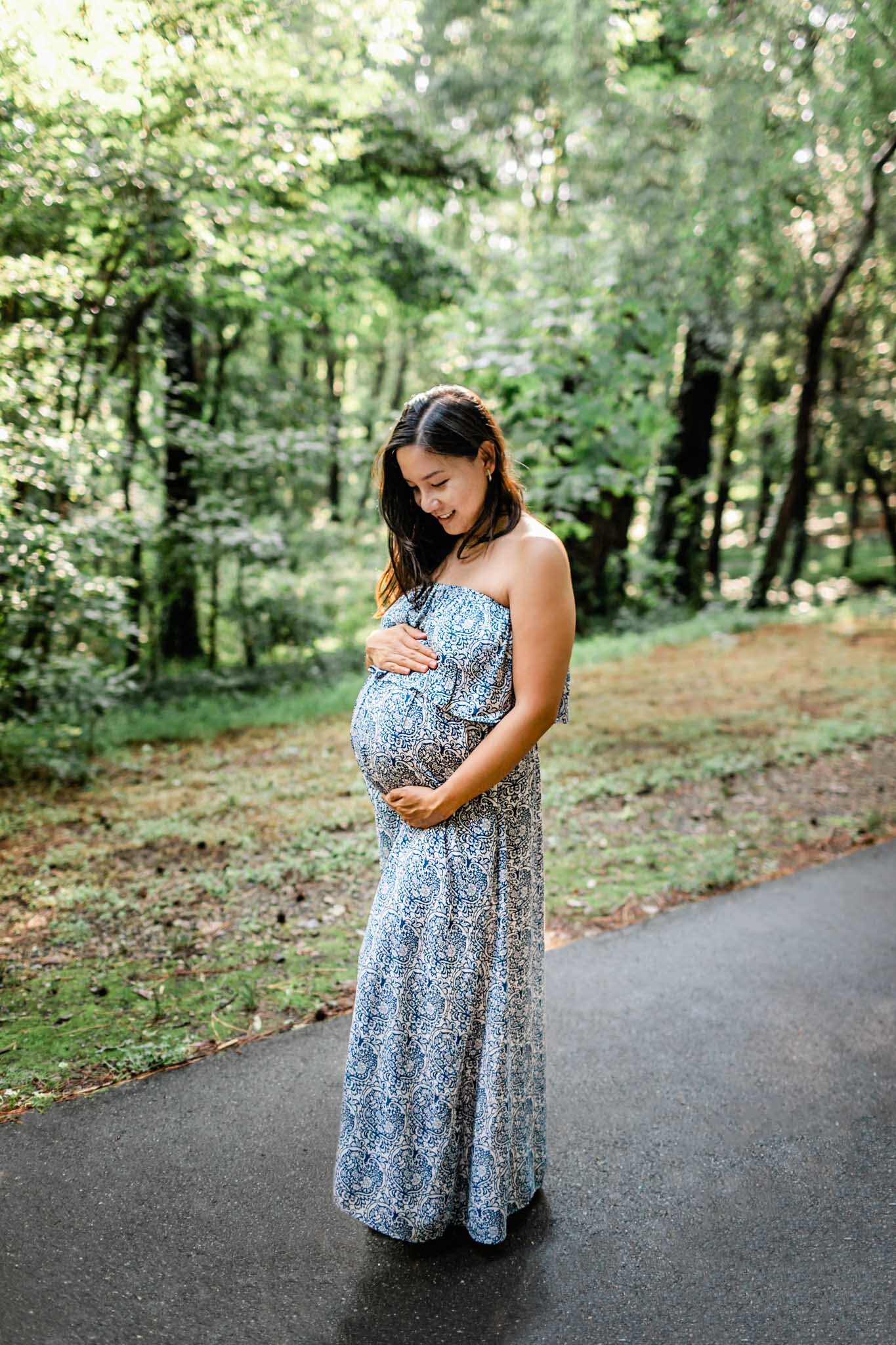 Raleigh Maternity Photographer | By G. Lin Photography | NCMA Maternity Photos | Woman standing and holding baby bump