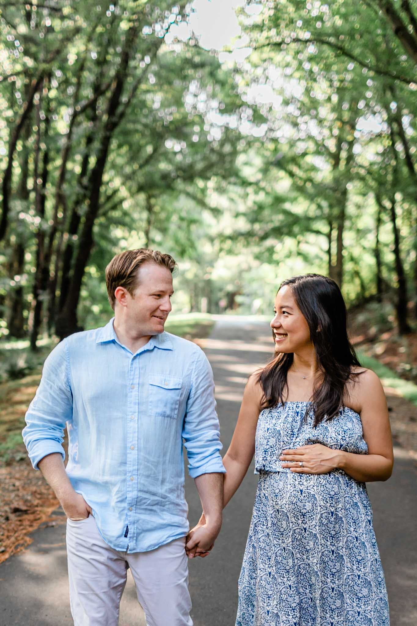 Raleigh Maternity Photographer | By G. Lin Photography | NCMA Maternity Photos | Couple walking down path of trees