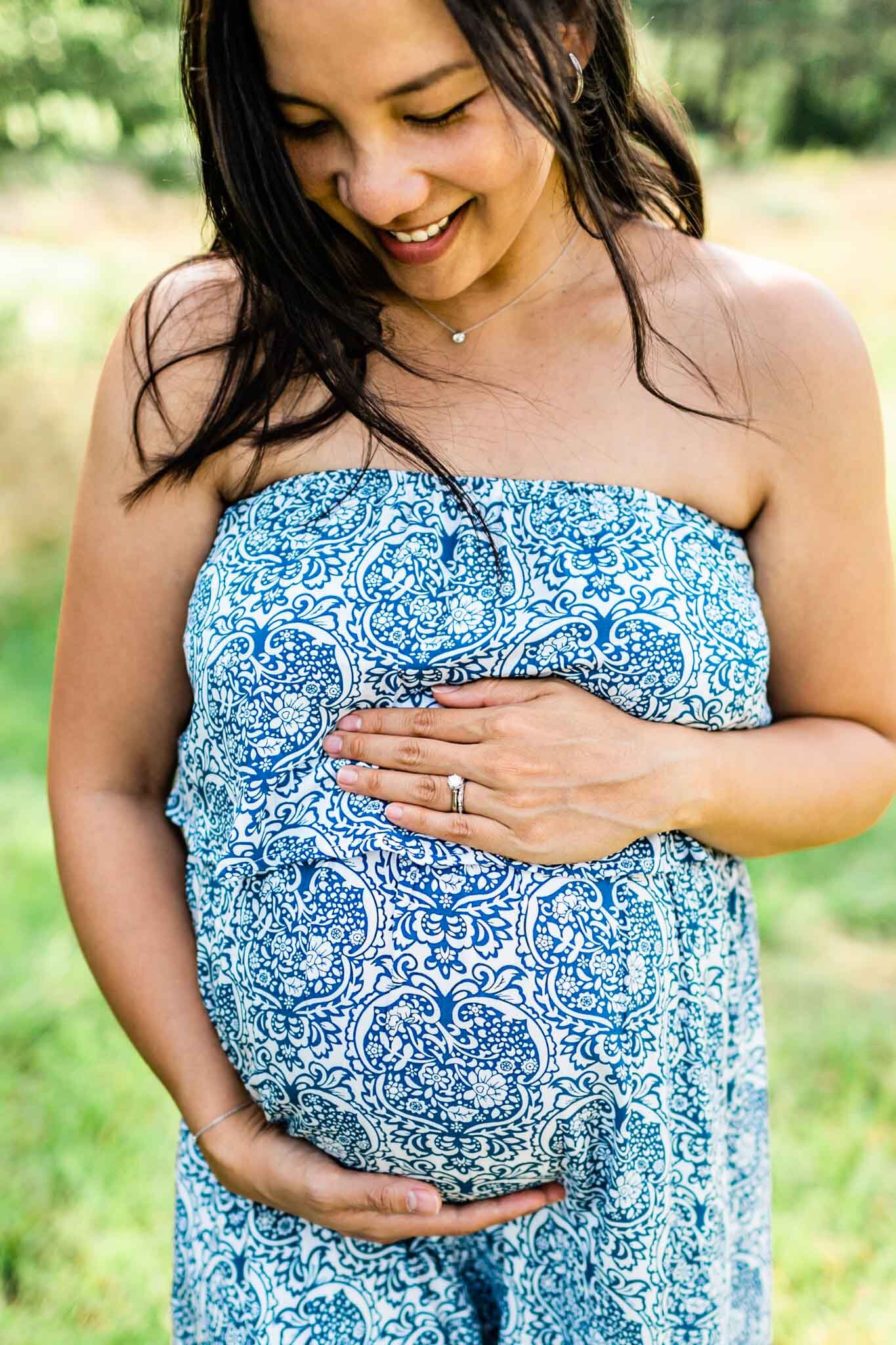 Raleigh Maternity Photographer | By G. Lin Photography | NCMA Maternity Photos | Bright cheerful photo of mother looking down at belly