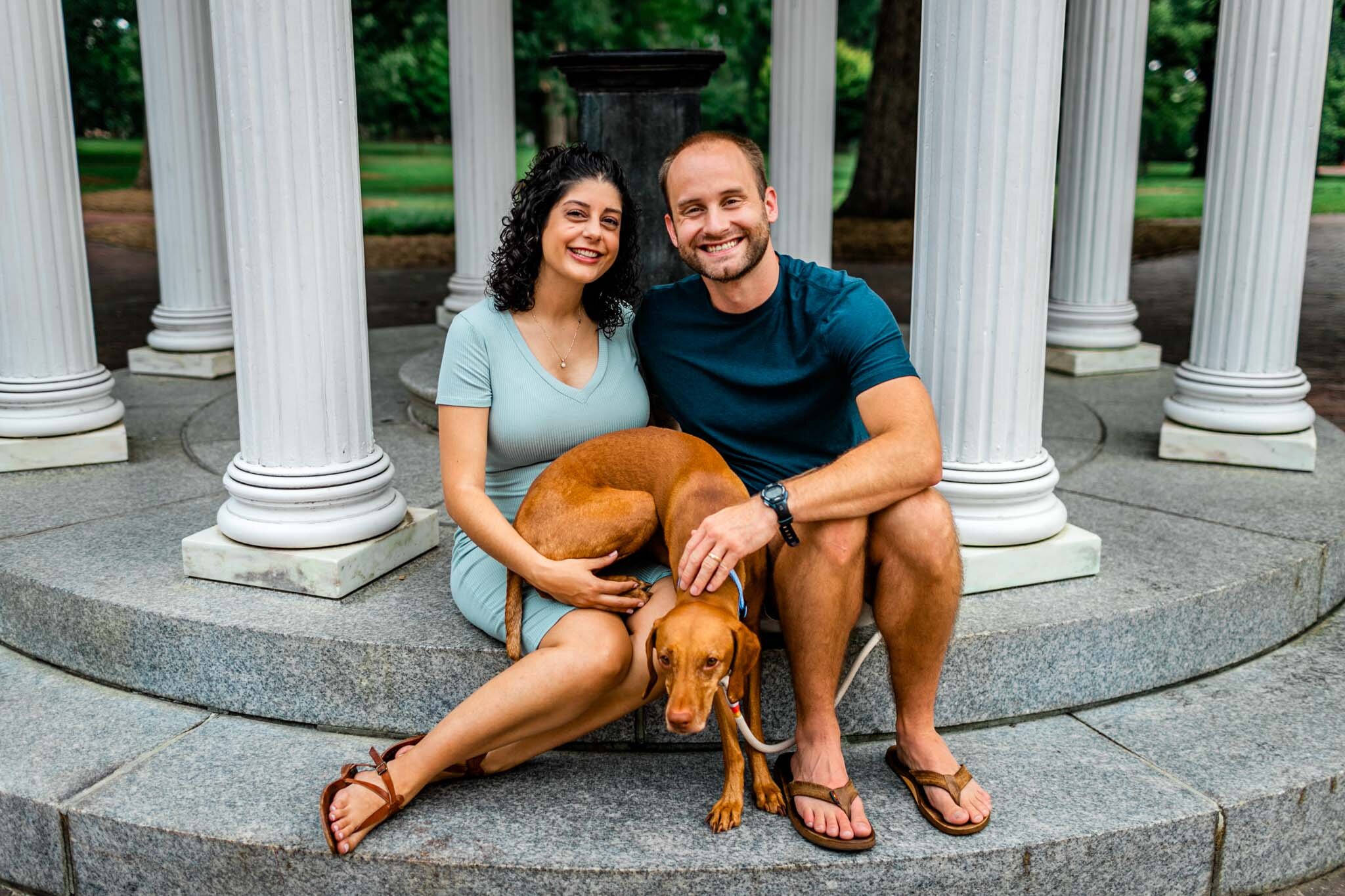 UNC Chapel Hill Maternity Photography | By G. Lin Photography | Couple with dog sitting by the Old Well