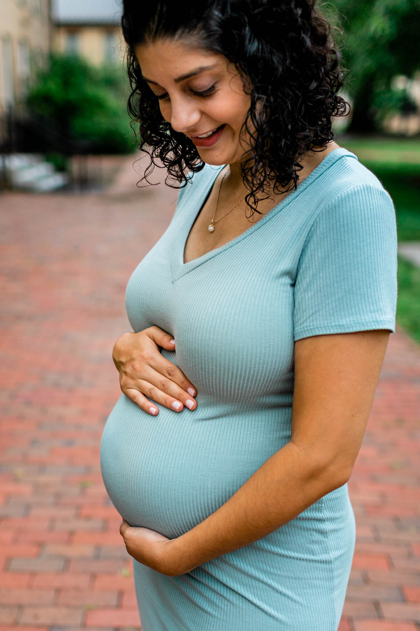 UNC Chapel Hill Maternity Photography | By G. Lin Photography | Woman looking down and touching baby bump