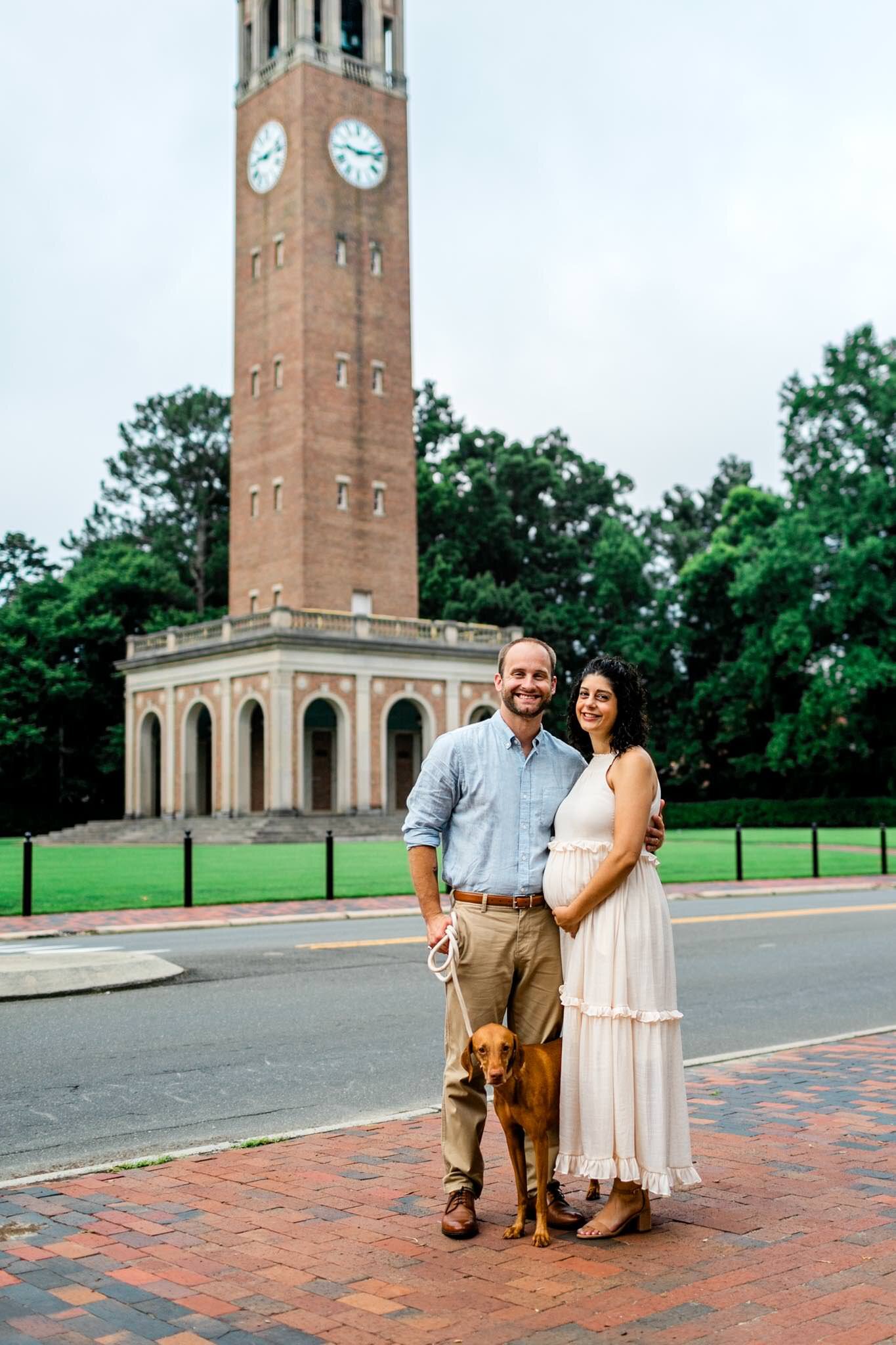 UNC Chapel Hill Maternity Photography | By G. Lin Photography | Couple standing with dog by the Bell Tower
