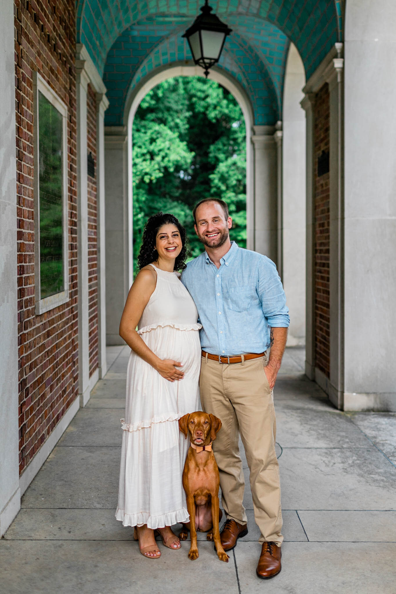 UNC Chapel Hill Maternity Photography | By G. Lin Photography | Couple standing with dog at the Bell Tower