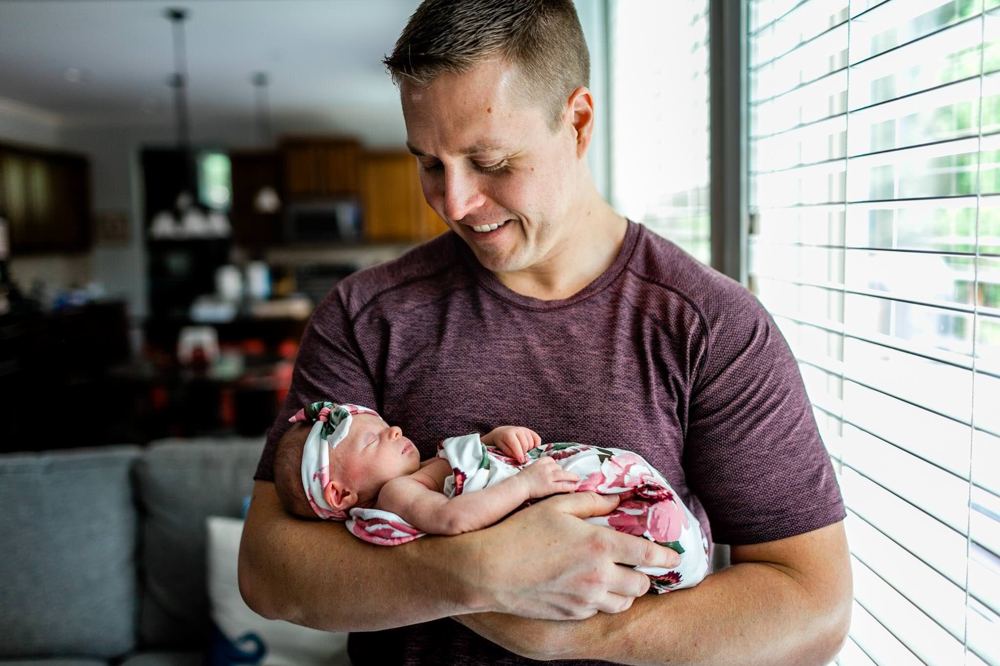 Hillsborough Newborn Photographer | By G. Lin Photography | Father holding baby girl next to window