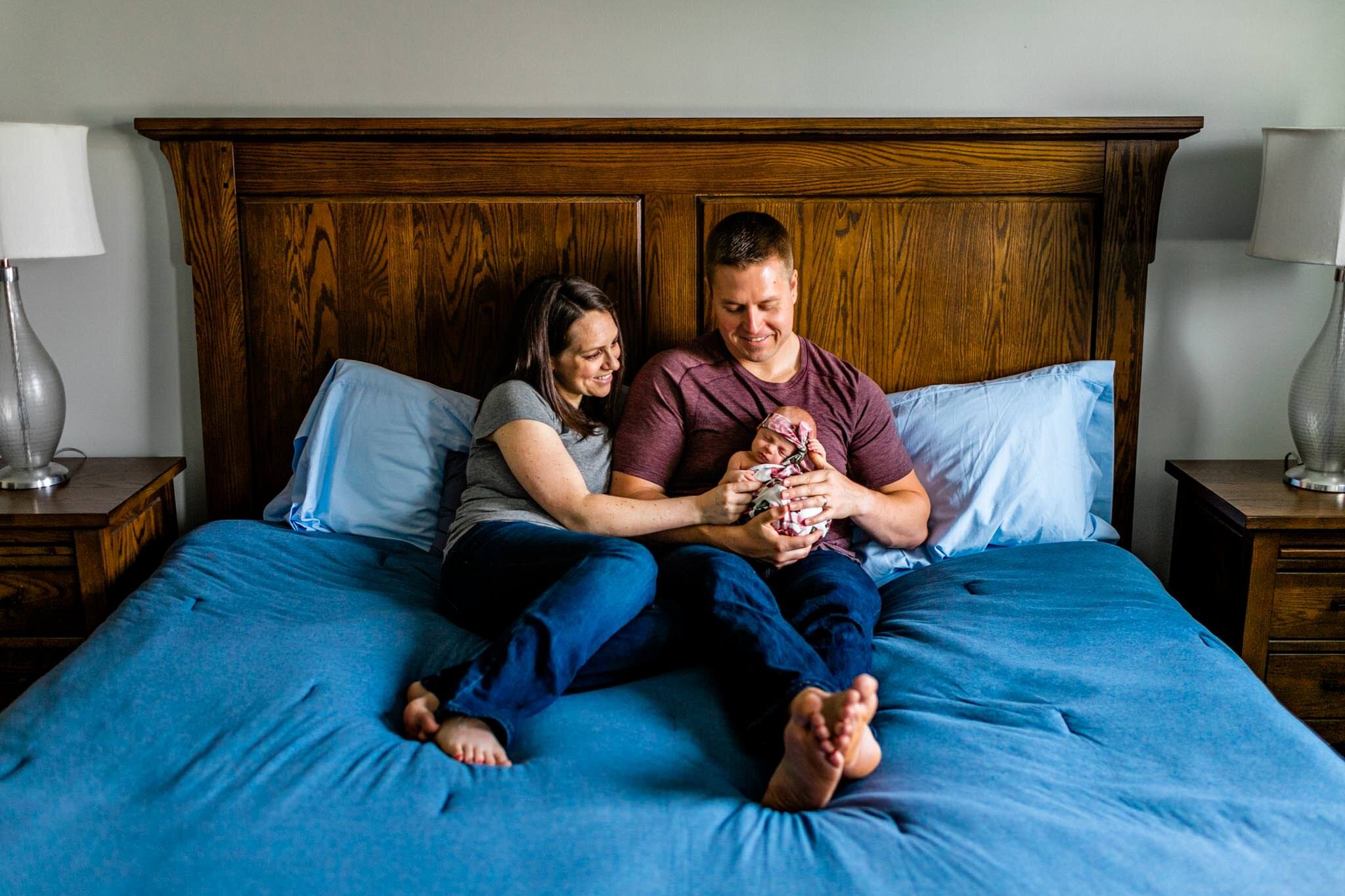 Hillsborough Newborn Photographer | By G. Lin Photography | Lifestyle newborn photo of parents holding baby in bedroom