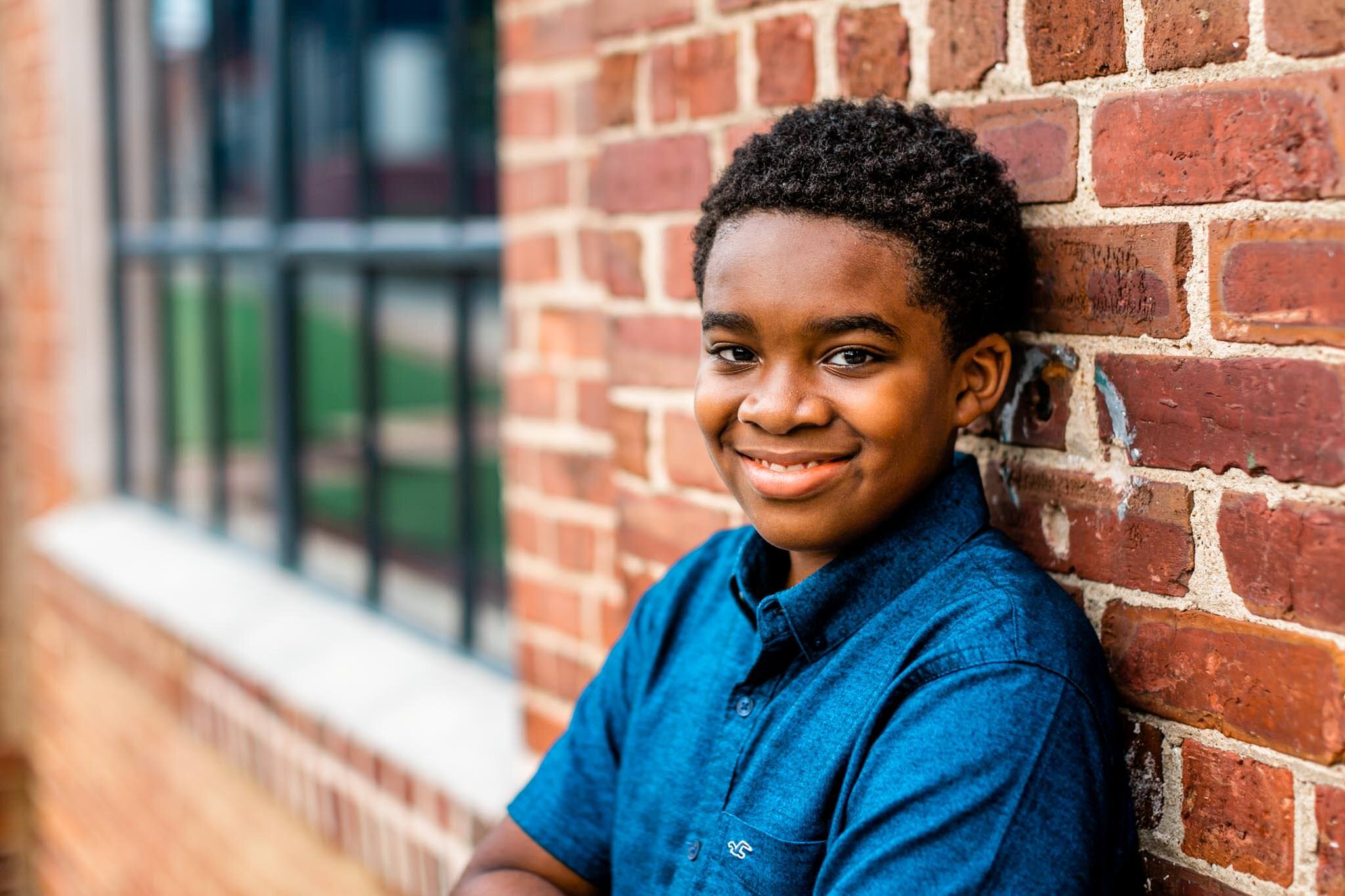 Durham Family Photographer | By G. Lin Photography | Young boy leaning on brick wall