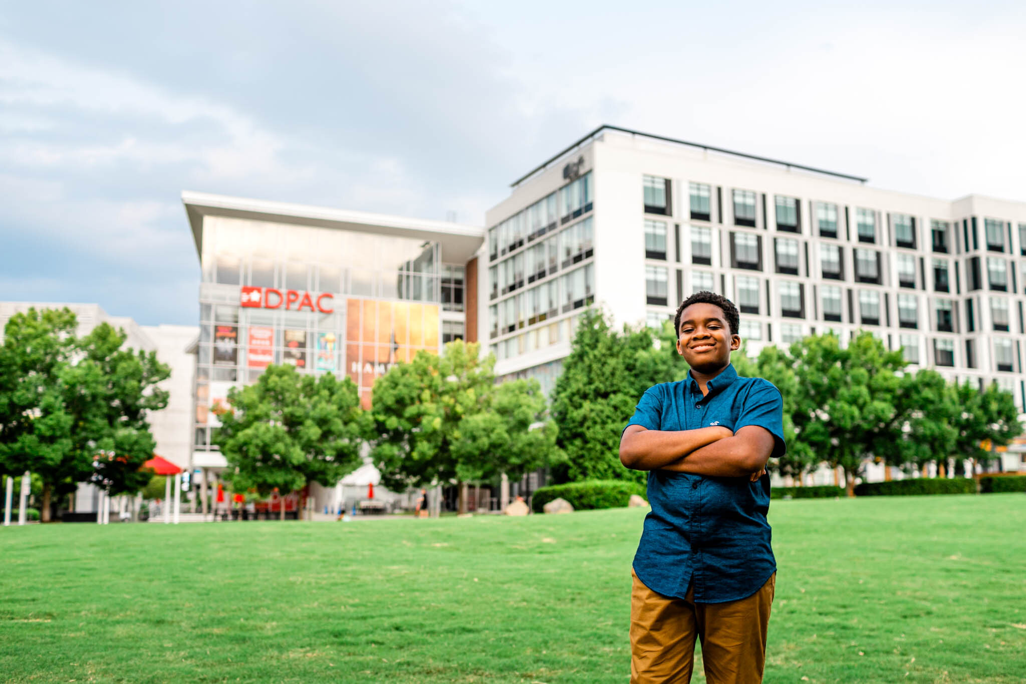 Durham Family Photographer | By G. Lin Photography | DPAC | Young boy standing next to building