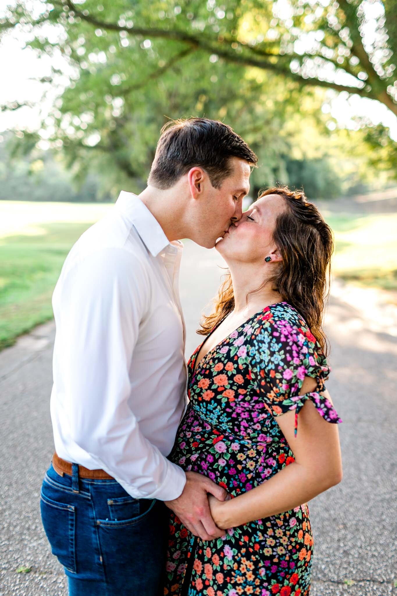 Raleigh Maternity Photographer | Dix Park | By G. Lin Photography | Man and woman kissing underneath trees