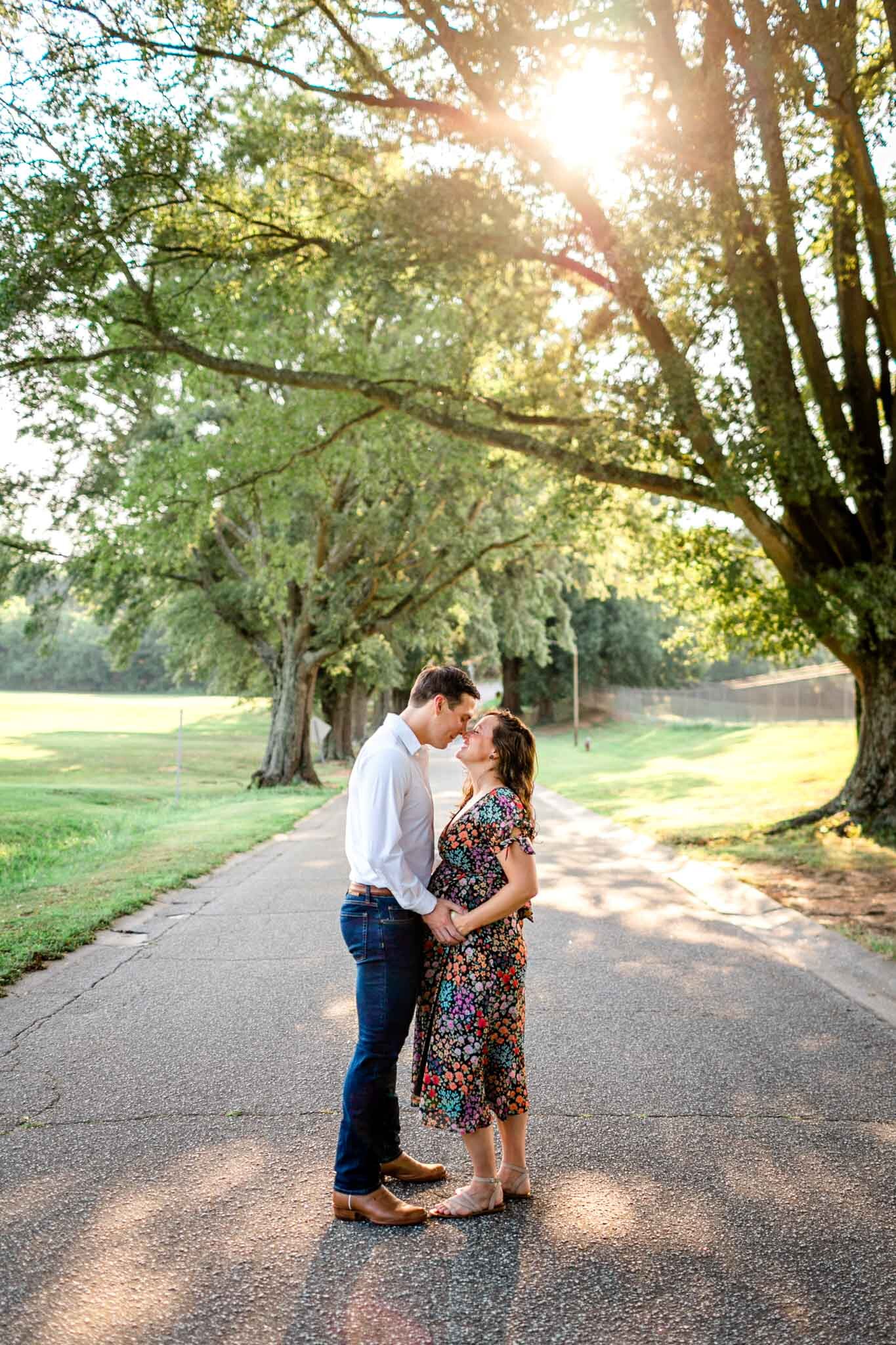 Raleigh Maternity Photographer | Dix Park | By G. Lin Photography | Beautiful candid shot of man and woman kissing