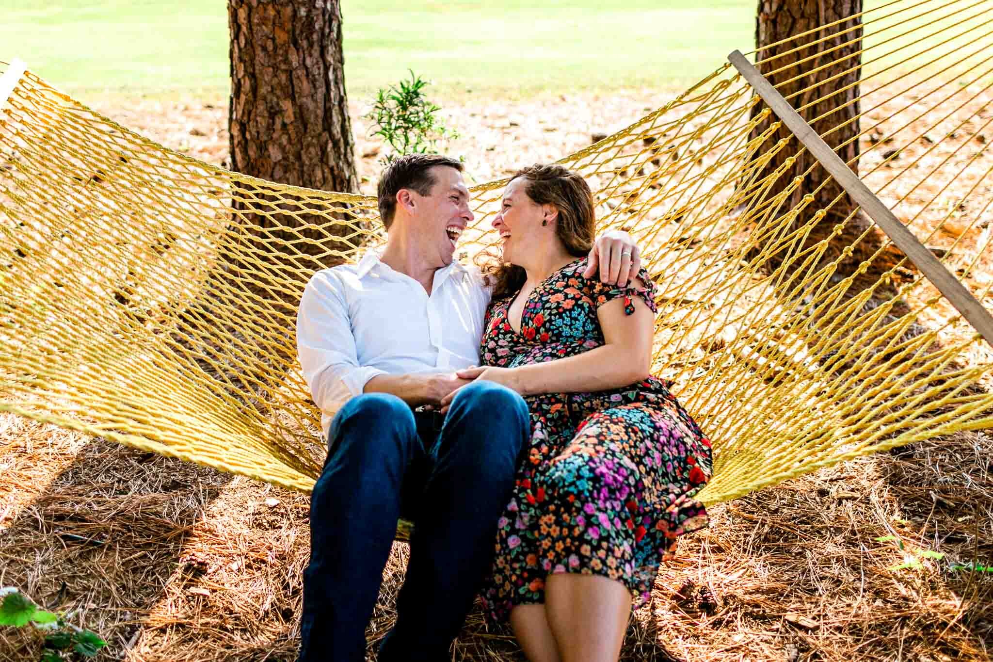 Raleigh Maternity Photographer | Dix Park | By G. Lin Photography | Couple sitting on yellow hammock