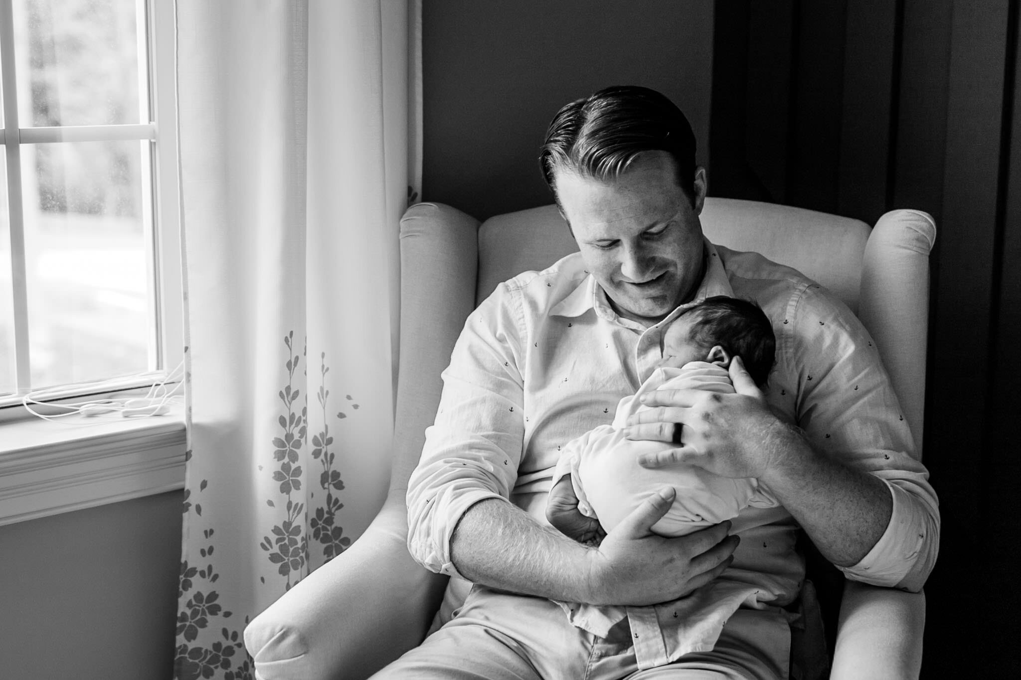 Pittsboro Newborn Photographer | By G. Lin Photography | Black and white photo of man holding baby boy