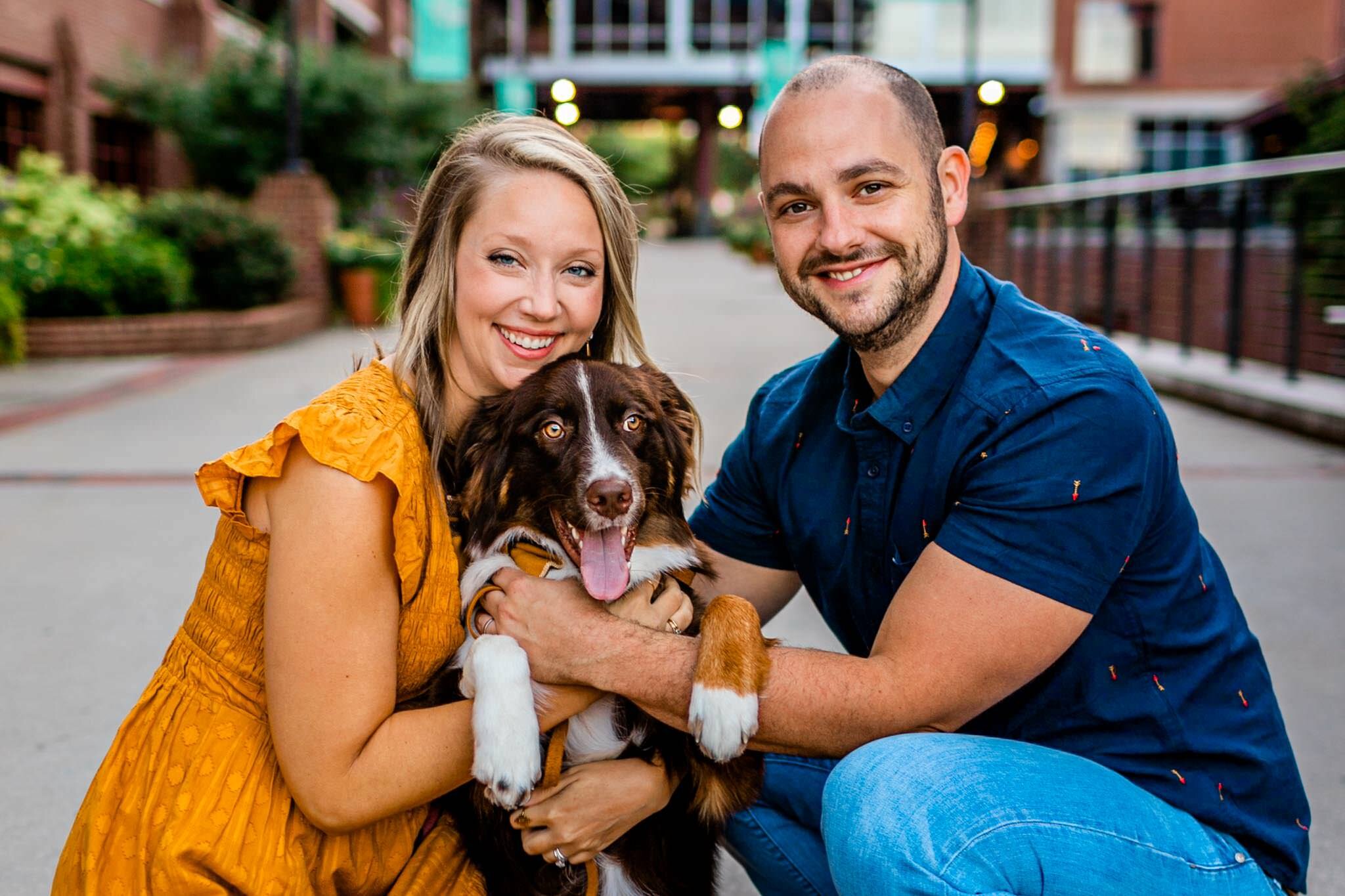 Durham Family Photographer | By G. Lin Photography | Beautiful candid photo of man and woman hugging dog and looking at camera