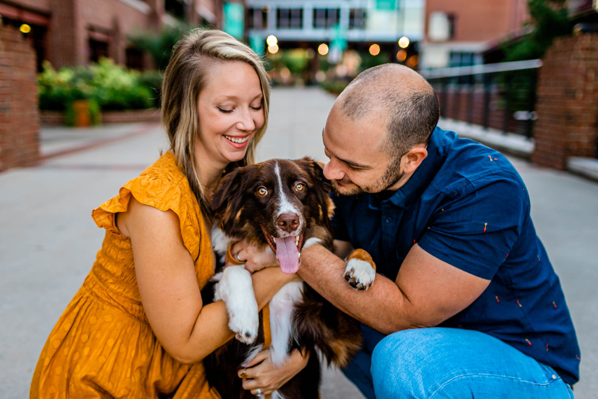 Durham Family Photographer | By G. Lin Photography | Family hugging dog at American Tobacco Campus