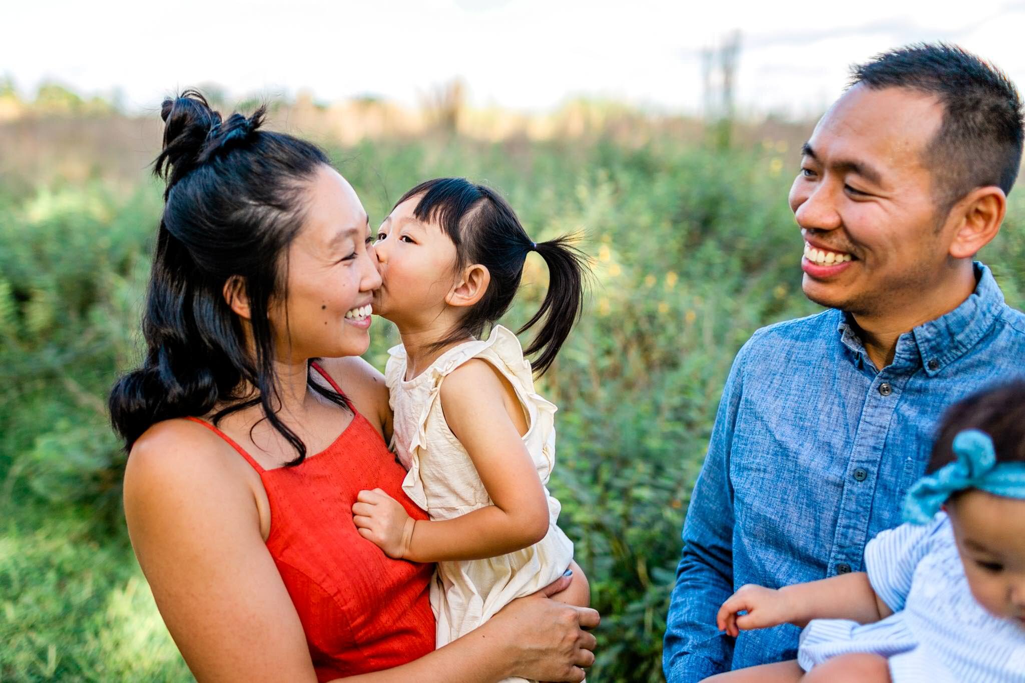 Raleigh Family Photographer | By G. Lin Photography | Young girl giving mom a kiss on the cheek