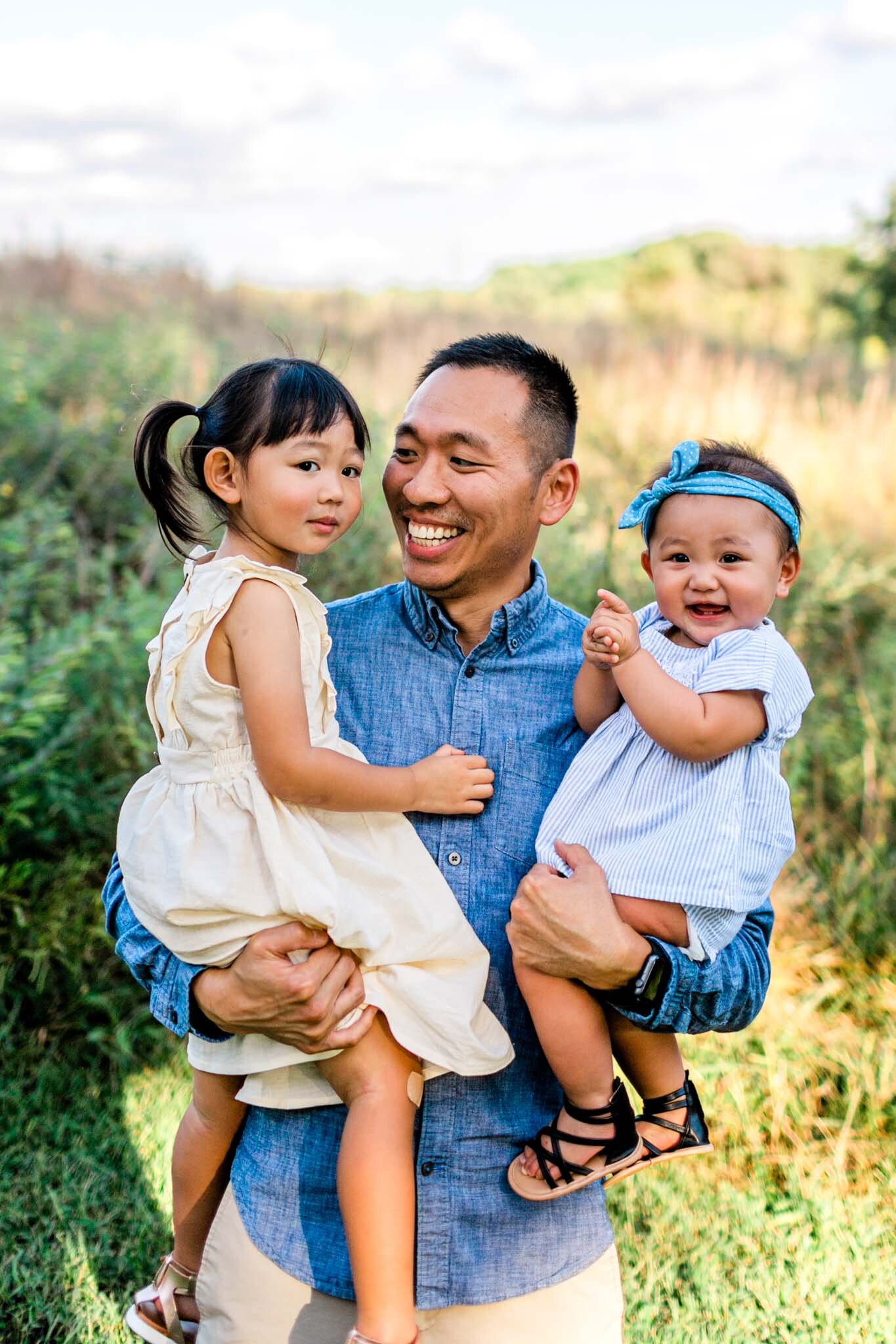 Raleigh Family Photographer | By G. Lin Photography | Father holding two daughters in his arms