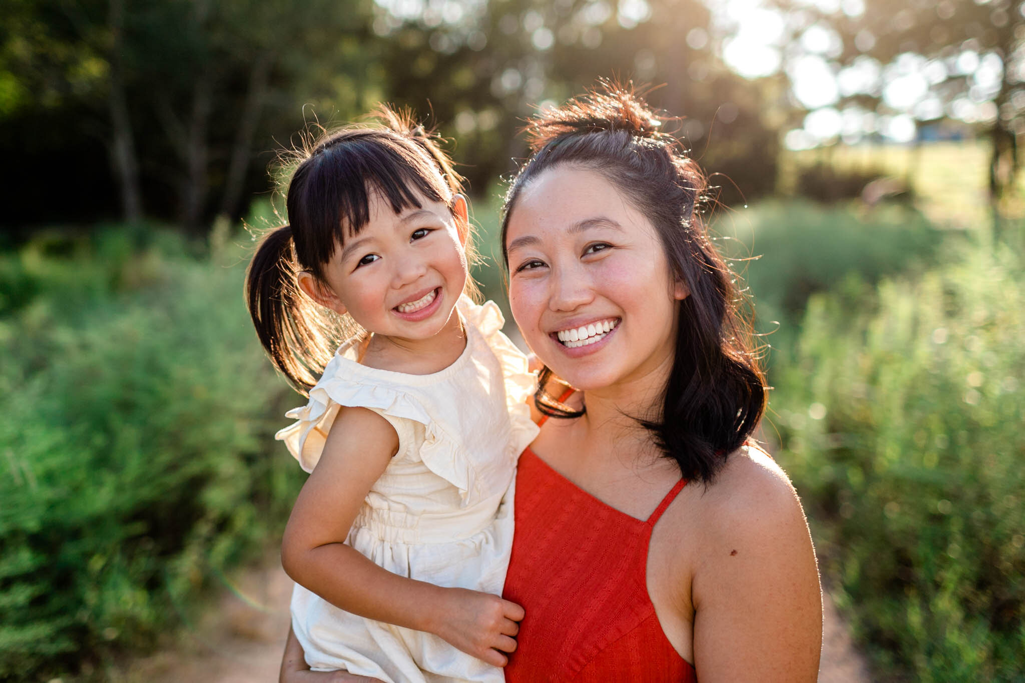 Raleigh Family Photographer | By G. Lin Photography | Beautiful mother and daughter smiling at camera in open field