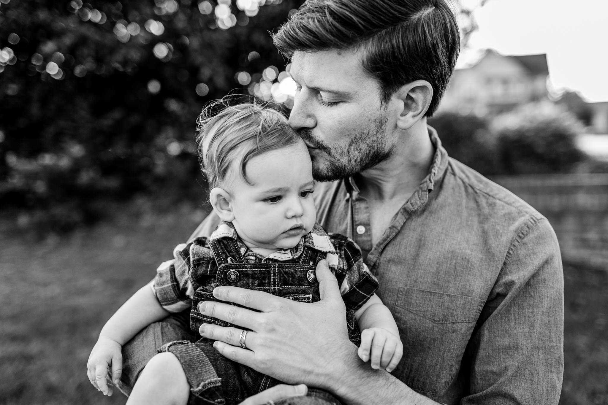 Durham Family Photographer | By G. Lin Photography | Black and white photo of dad kissing baby boy