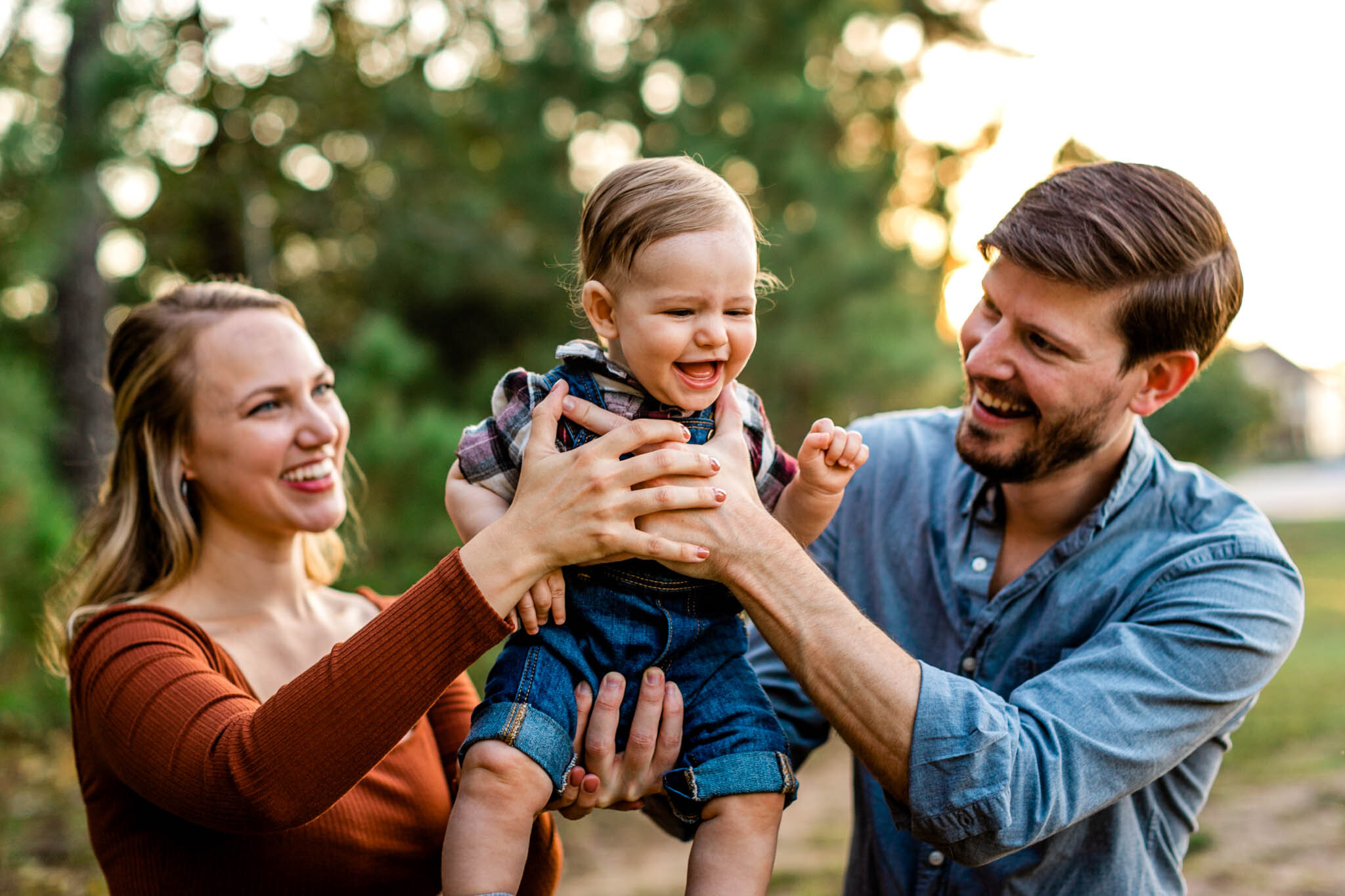 Durham Family Photographer | By G. Lin Photography | Mom and dad holding baby boy in the air and laughing