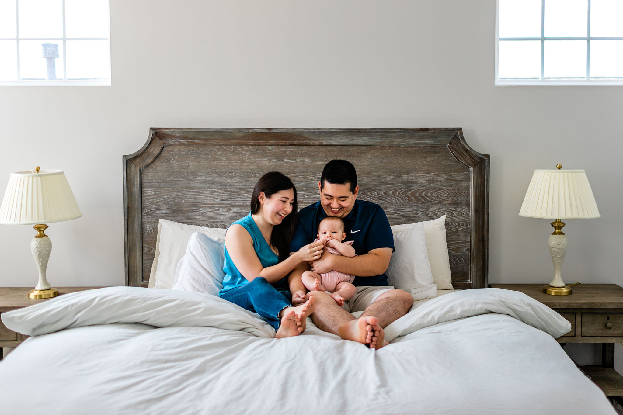 Raleigh Family Photographer | By G. Lin Photography | Couple sitting on bed with baby