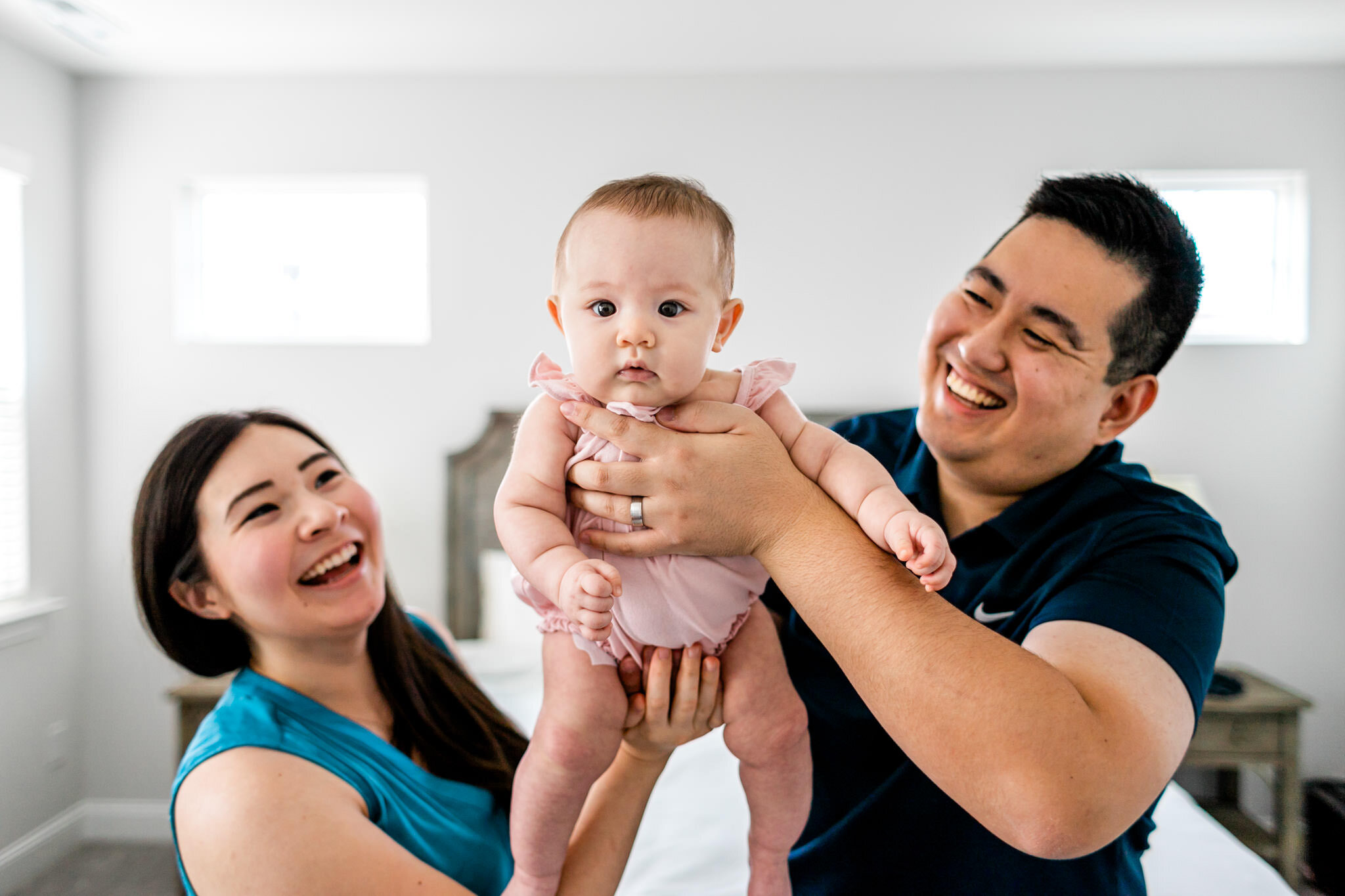 Raleigh Family Photographer | By G. Lin Photography | Man and woman smiling at baby 