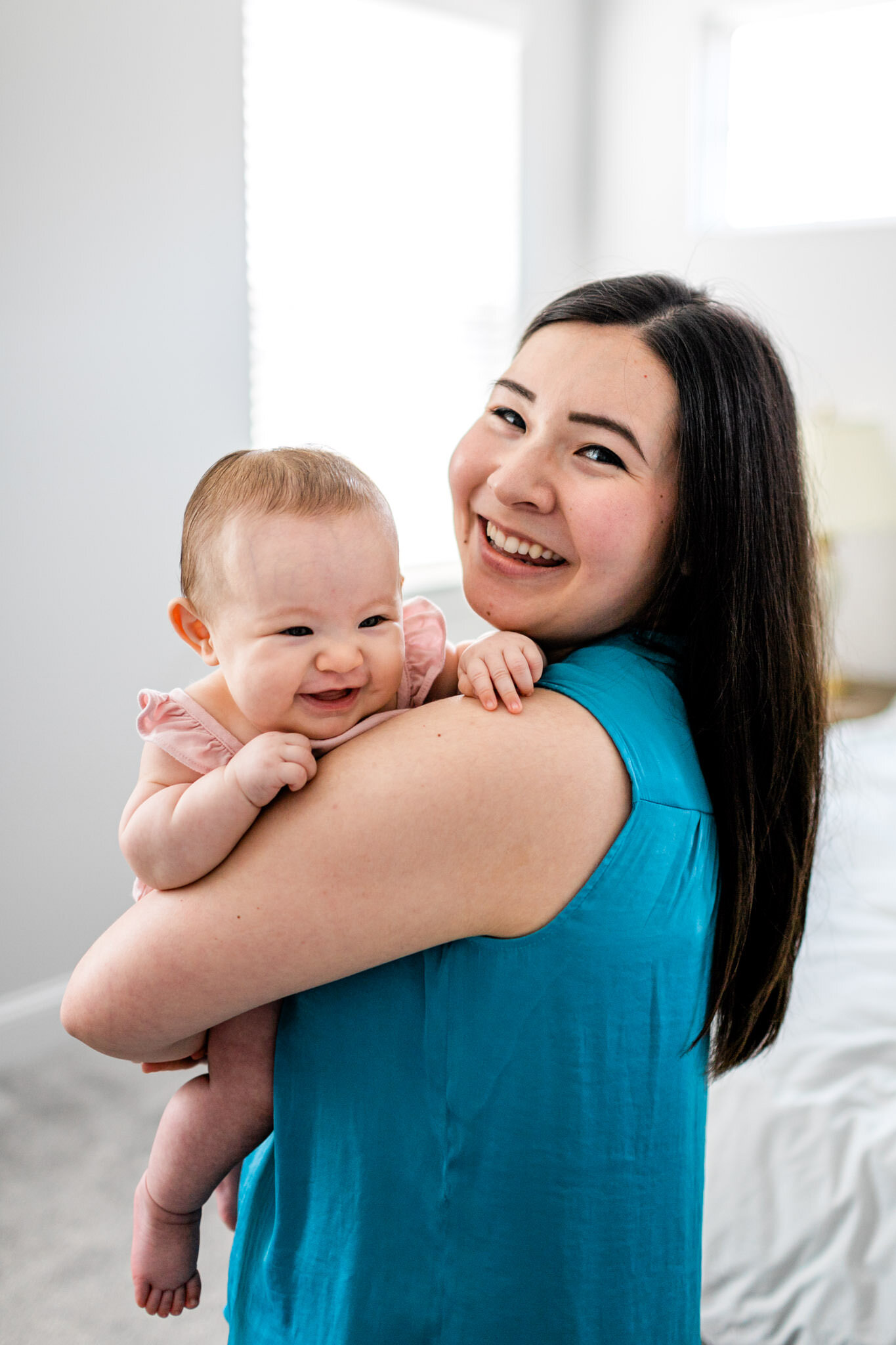 Raleigh Family Photographer | By G. Lin Photography | Mom smiling and holding baby girl
