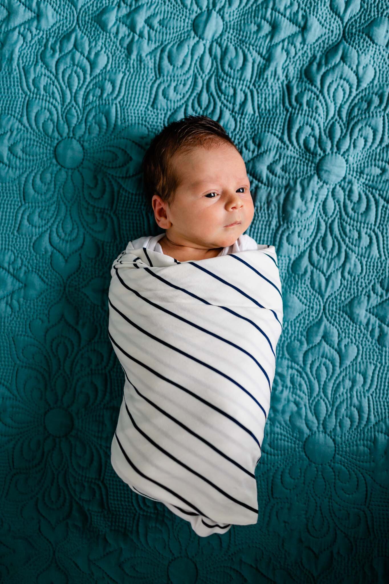 Durham Newborn Photographer | By G. Lin Photography | Baby boy laying on teal bed