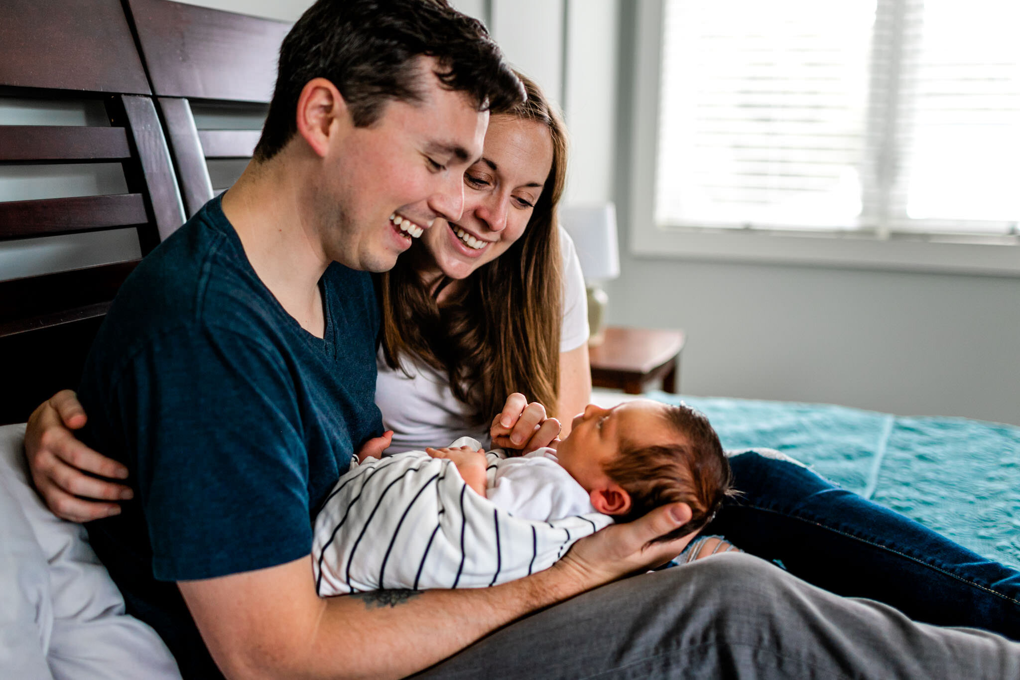 Durham Newborn Photographer | By G. Lin Photography | Parents looking at newborn baby boy with smiles