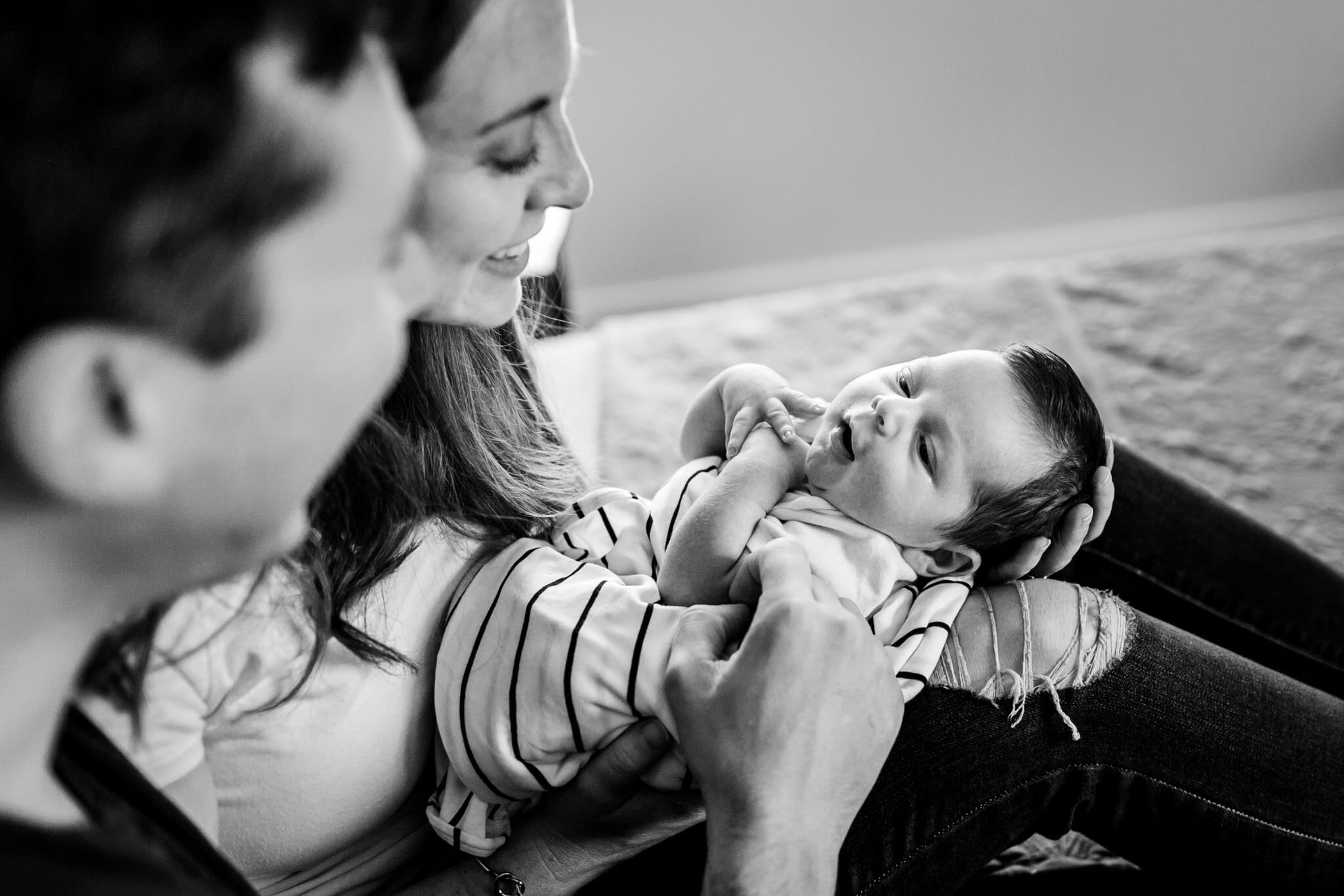Durham Newborn Photographer | By G. Lin Photography | Black and white photo of baby smiling at parents