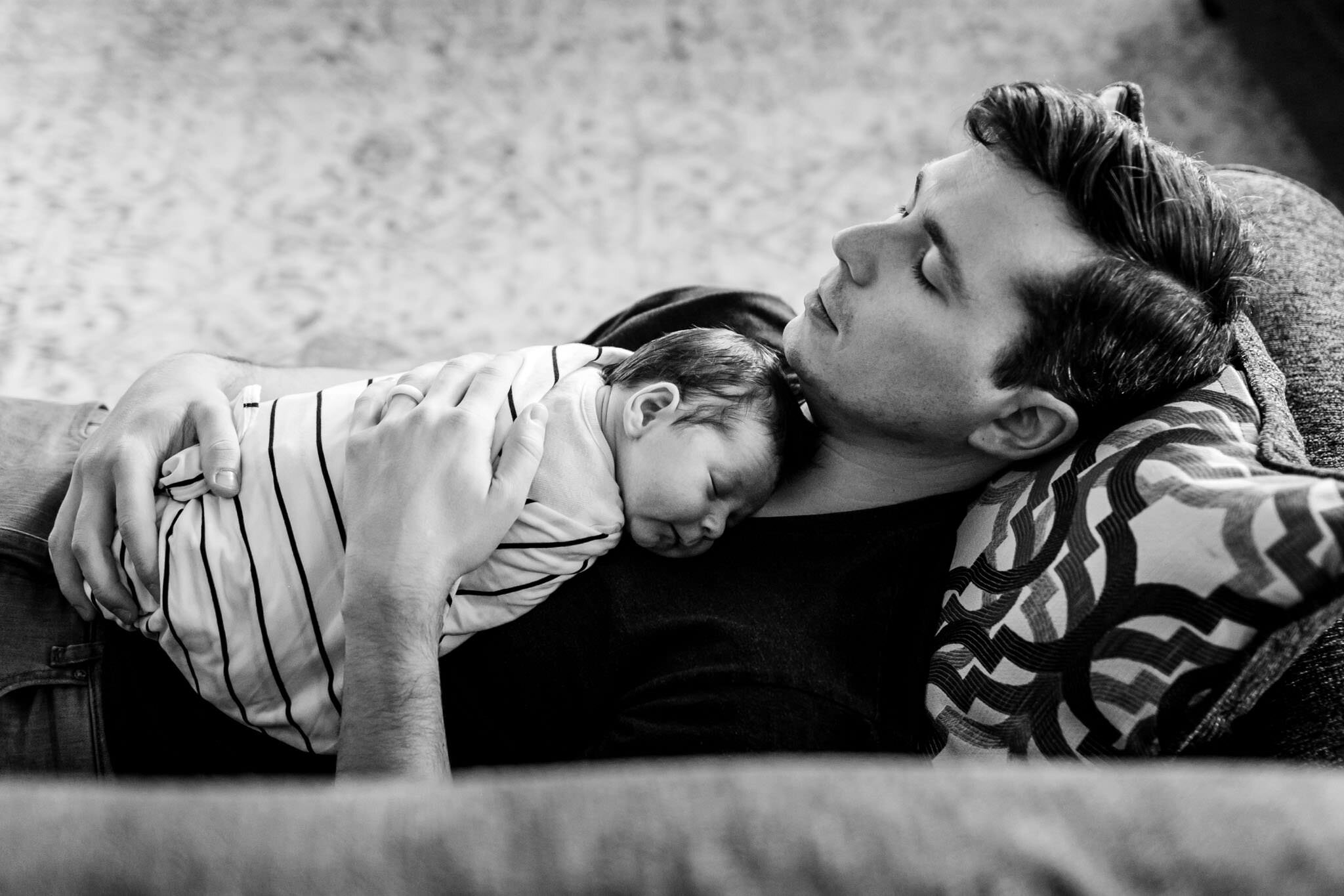 Durham Newborn Photographer | By G. Lin Photography | Father holding baby and napping on couch