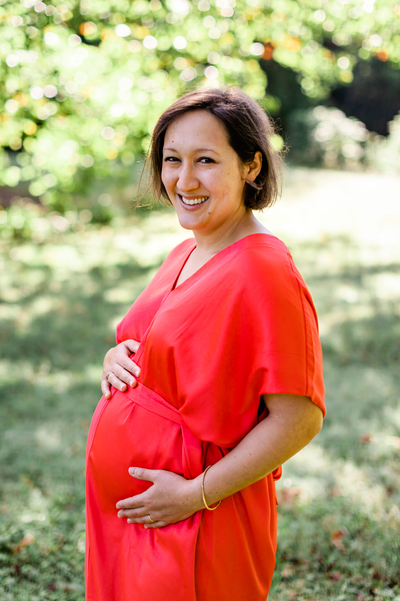 Maternity Shoot at Ayr Mount | Hillsborough Maternity Photographer | By G. Lin Photography | Woman smiling at camera and embracing bump