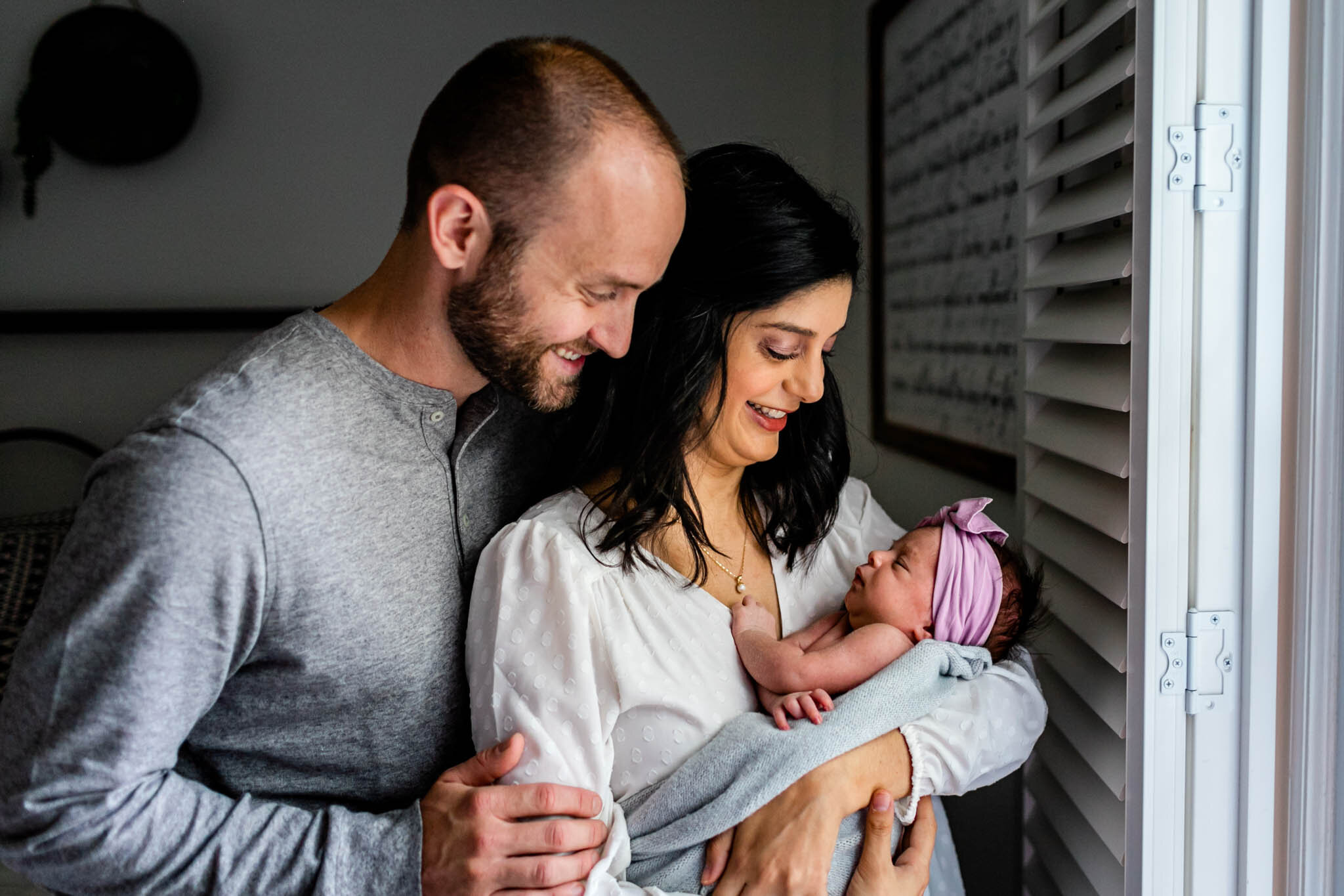 Charlotte Newborn Photographer | By G. Lin Photography | Parents looking at baby girl