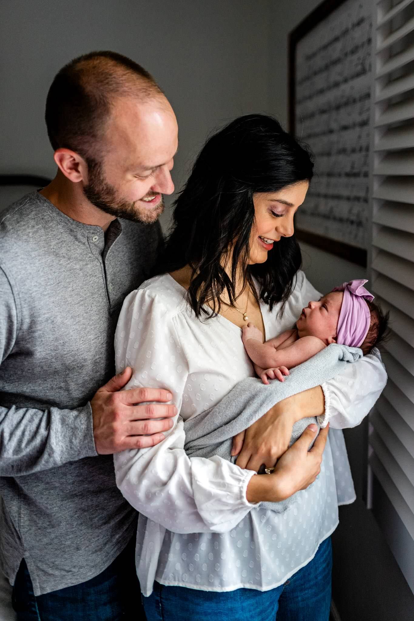 Charlotte Newborn Photographer | By G. Lin Photography | Mother and father holding baby girl