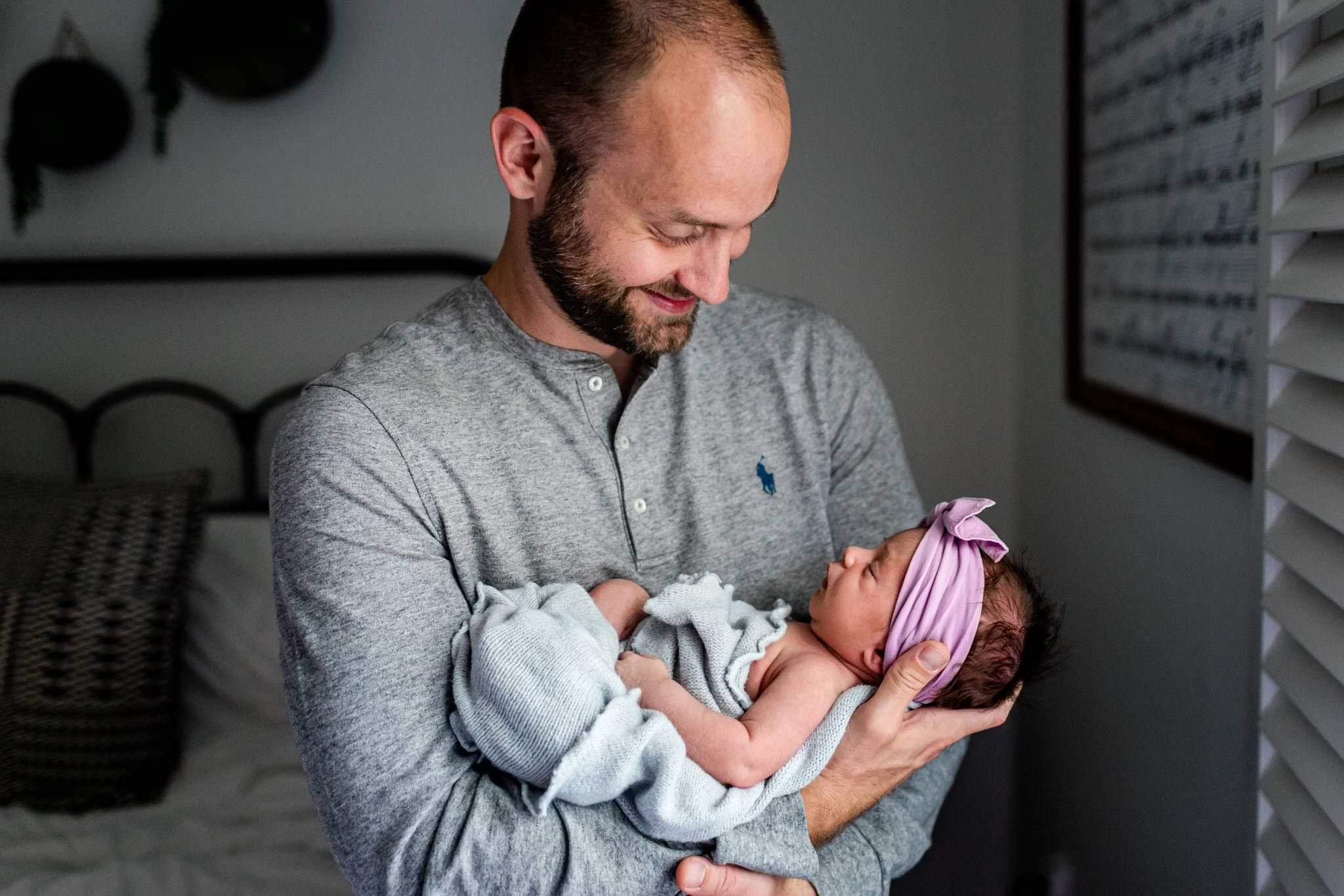 Charlotte Newborn Photographer | By G. Lin Photography | Dad holding baby girl by window