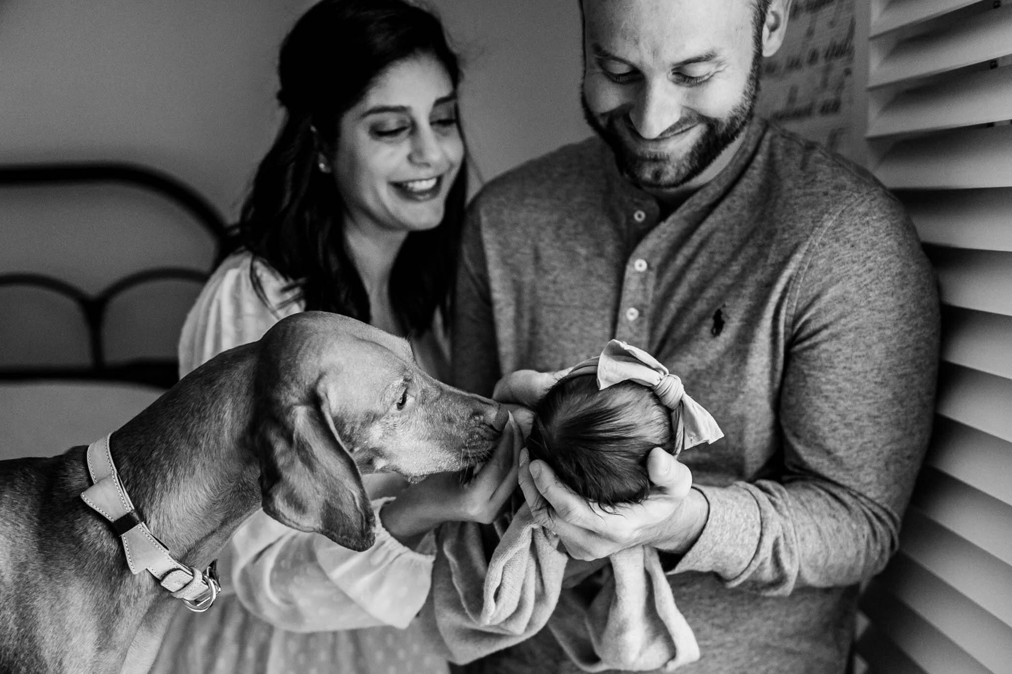 Charlotte Newborn Photographer | By G. Lin Photography | Candid black and white photo of family with baby