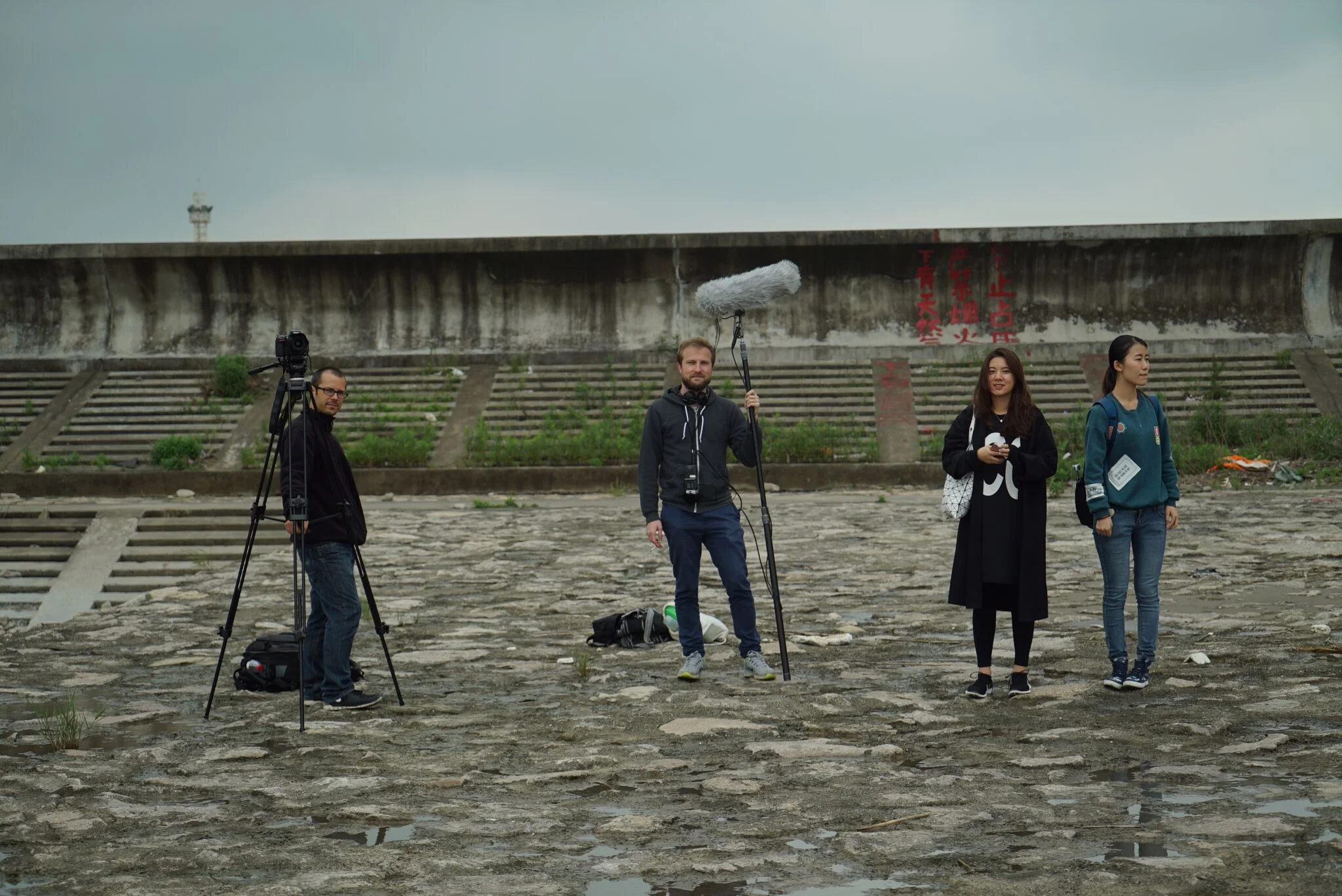 From right to left: Shi Xinxing (Pre-Production work), Xu Cong (line producer) and Titus Bütler (editor) waiting for the next shot of the dragon dance performance.