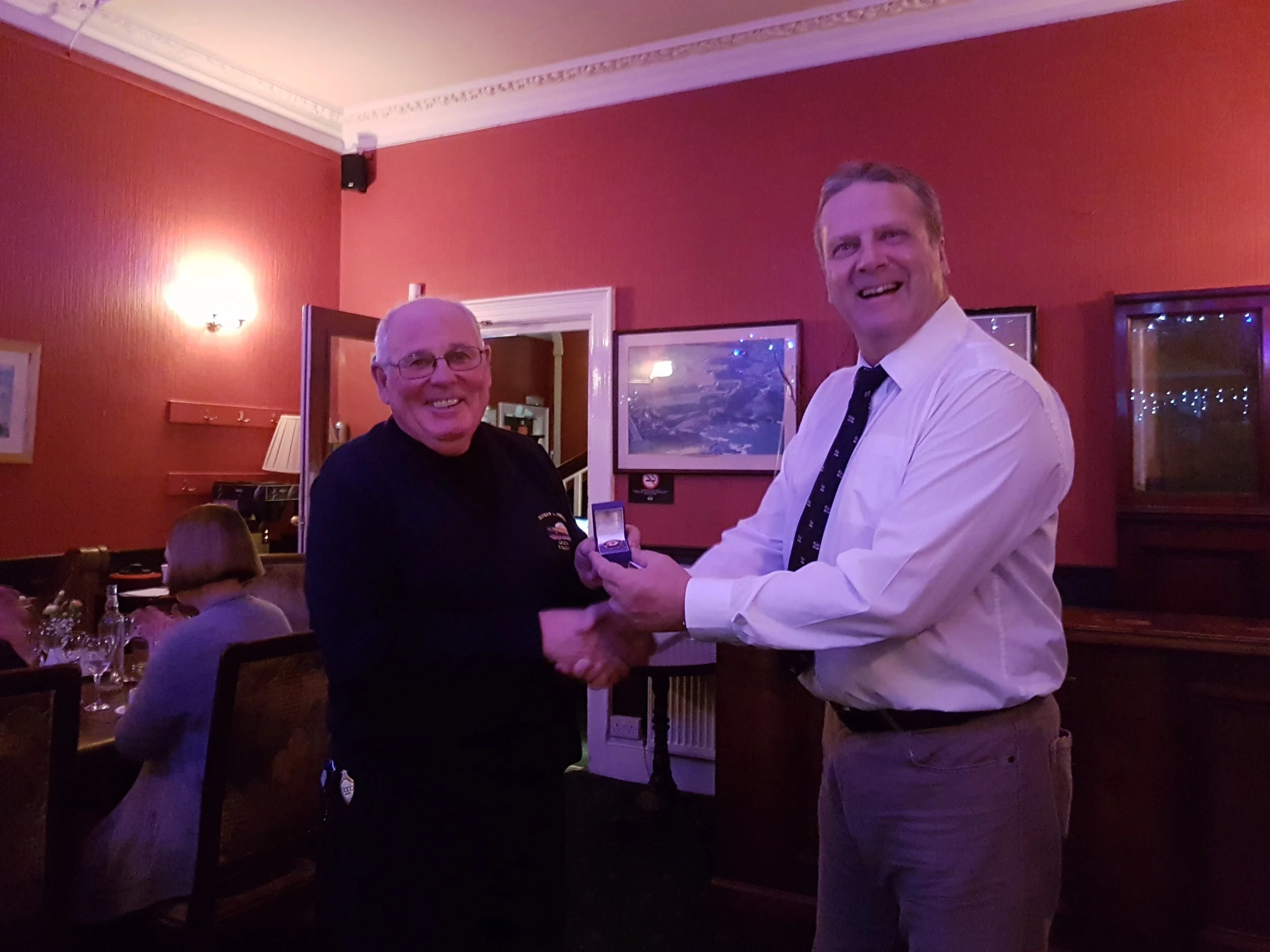 Mike on the left being presented his long service medal by Dave Anderson the lifeboat operations manager at Dunbar.