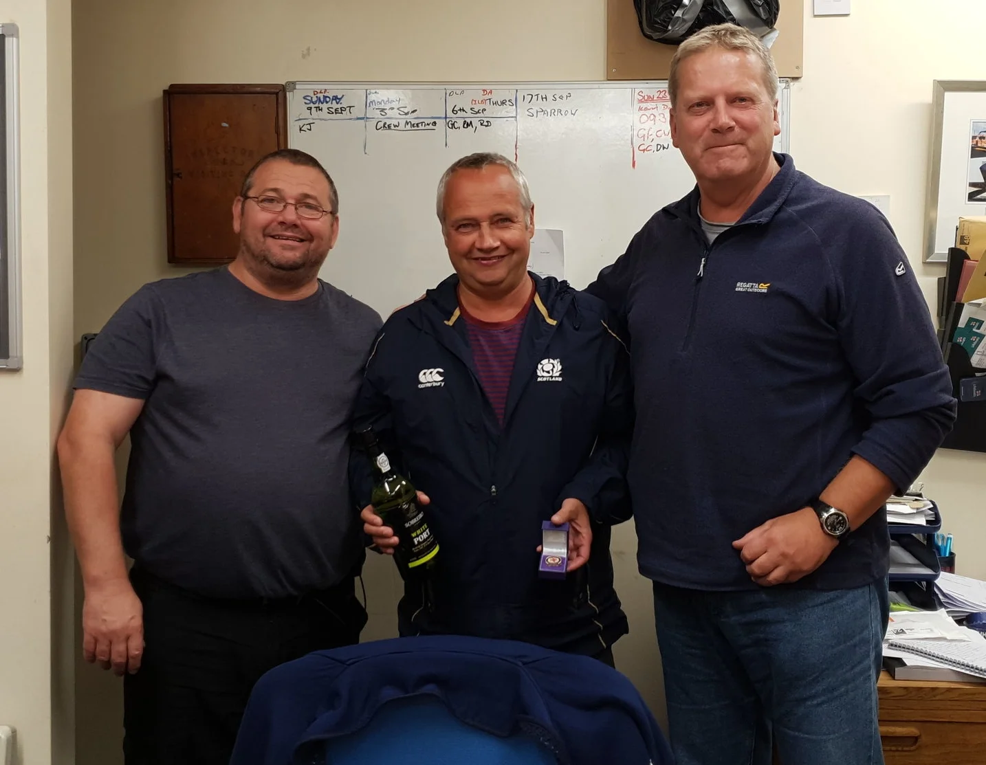 Mark Anderson (centre) receives his long service badge from coxswain Gary Fairbairn (left) and lifeboat operations manager (LOM) Dave Anderson (right). (Photo: Gaz Crowe)