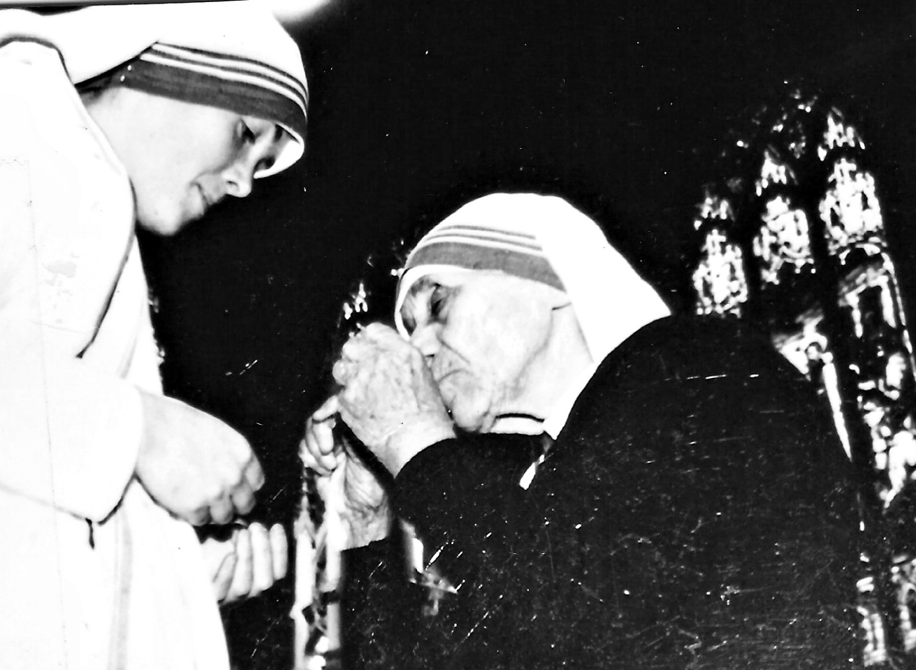 Mother Mary Catherine (then Sr.M. John Fisher) receiving crucifix from Bl. Mother Teresa of Calcutta, MC after professing her first vows in San Francisco, 1991.