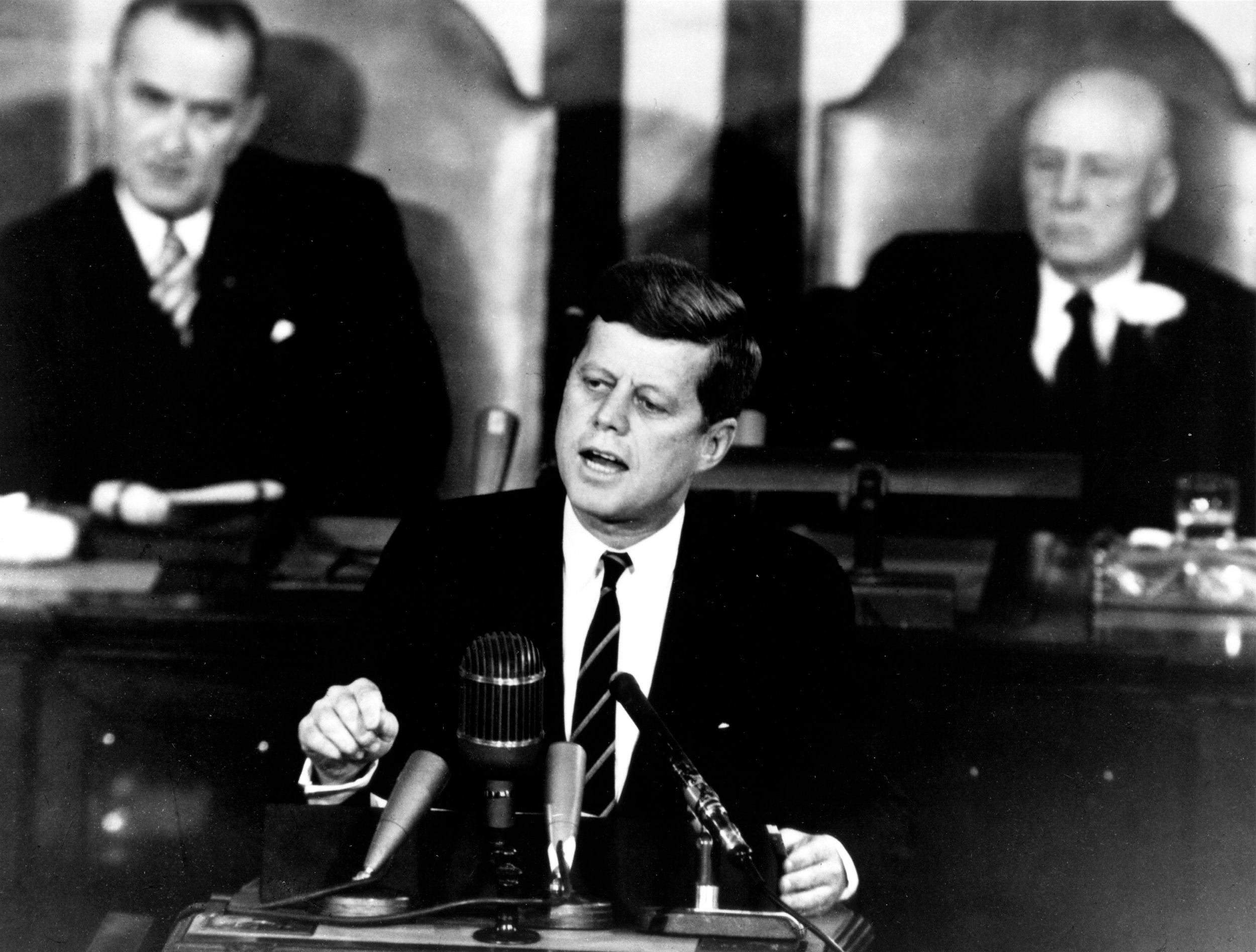 President Kennedy Addresses Congress May 25, 1961. Shown in the background are, (left) Vice President Lyndon Johnson, and (right) Speaker of the House Sam T. Rayburn. Image #: 70-H-1075 . 