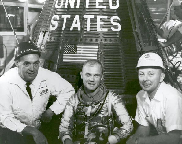 January 24, 1962: John Glenn With T.J. O'Malley and Paul Donnelly in Front of Friendship 7. Grouped together with astronaut John H. Glenn, Jr., beside "Friendship 7" spacecraft are left to right: T.J. O'Malley, chief test conductor for General Dynam…