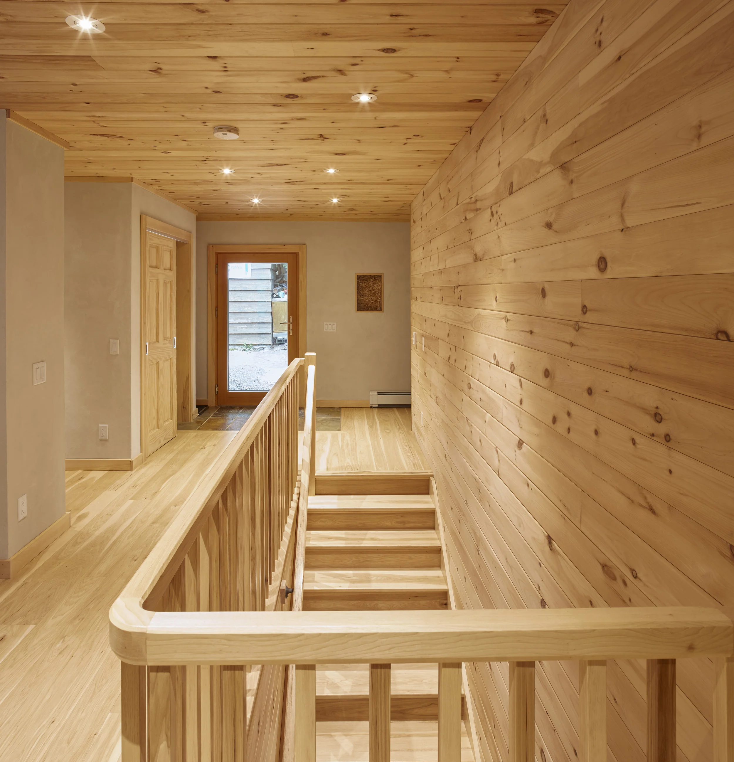 Hallway, stairs wood floor, ceiling, straw bale "truth window"