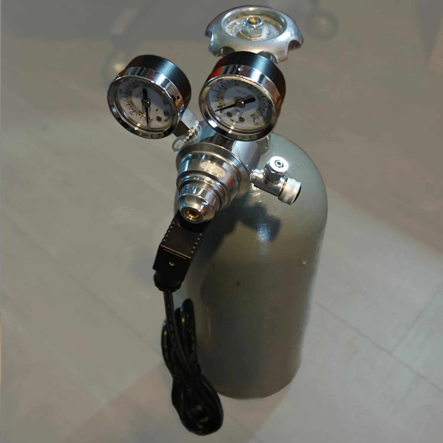 To begin the set up process of the Co2 system, you will need a filled cylinder. What size tank you buy depends on how often you want to have to fill it. Shown is a standard 5lb tank. This should last roughly 4-5 months on a nano tank of 6-9 gallons depending on how much Co2 you use in a given day. Once you have a filled tank, you are ready to start assembling the other parts of the system. Begin with attaching the regulator to the threading of the tank. It is not recommended that you use teflon tape on the threads as it increases the risk of getting pieces of the tape inside the regulator, which can ruin it. However, in our experience, we like the security that the teflon provides against leaking, so if you want to use it we recommend only putting it on the rear 50% of the threads thus keeping the lead threading free of the teflon tape, ensuring that no tape gets into the regulator. Before attaching the regulator to the threading double check that the 0-ring is in place within the inner core of the threading. Most regulators require only hand-tightening to attach them securely to the tank, however if you feel it needs more, there is nothing wrong with a light quarter turn of an appropriate sized wrench but you do not want to apply much torque and you do not need to make it as tight as possible to get a secure fit. Please read the instructions that come with your regulator so that you know what else needs to be done before turning on your system. In some cases you will be asked to loosen the working pressure knob on your regulator before attaching to the system. You will also want to make sure that your speed control valve, also called the flow adjustment valve, is closed or off. This is important. 
