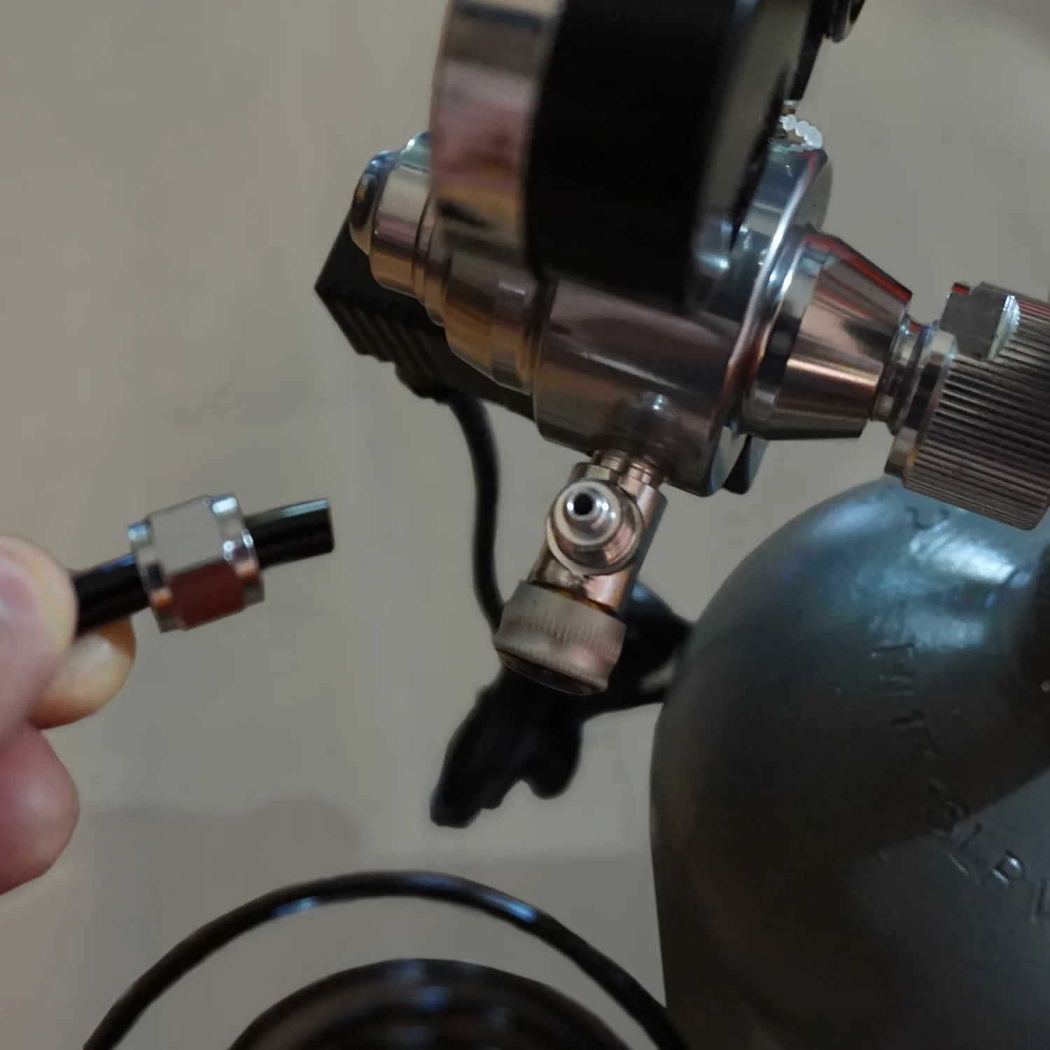 Unscrew the Co2 line connector nut from the regulator as shown. Slip the Co2 tubing through the nut. Then place the tubing over the tubing nipple on the regulator and tighten the nut to secure the tubing. 