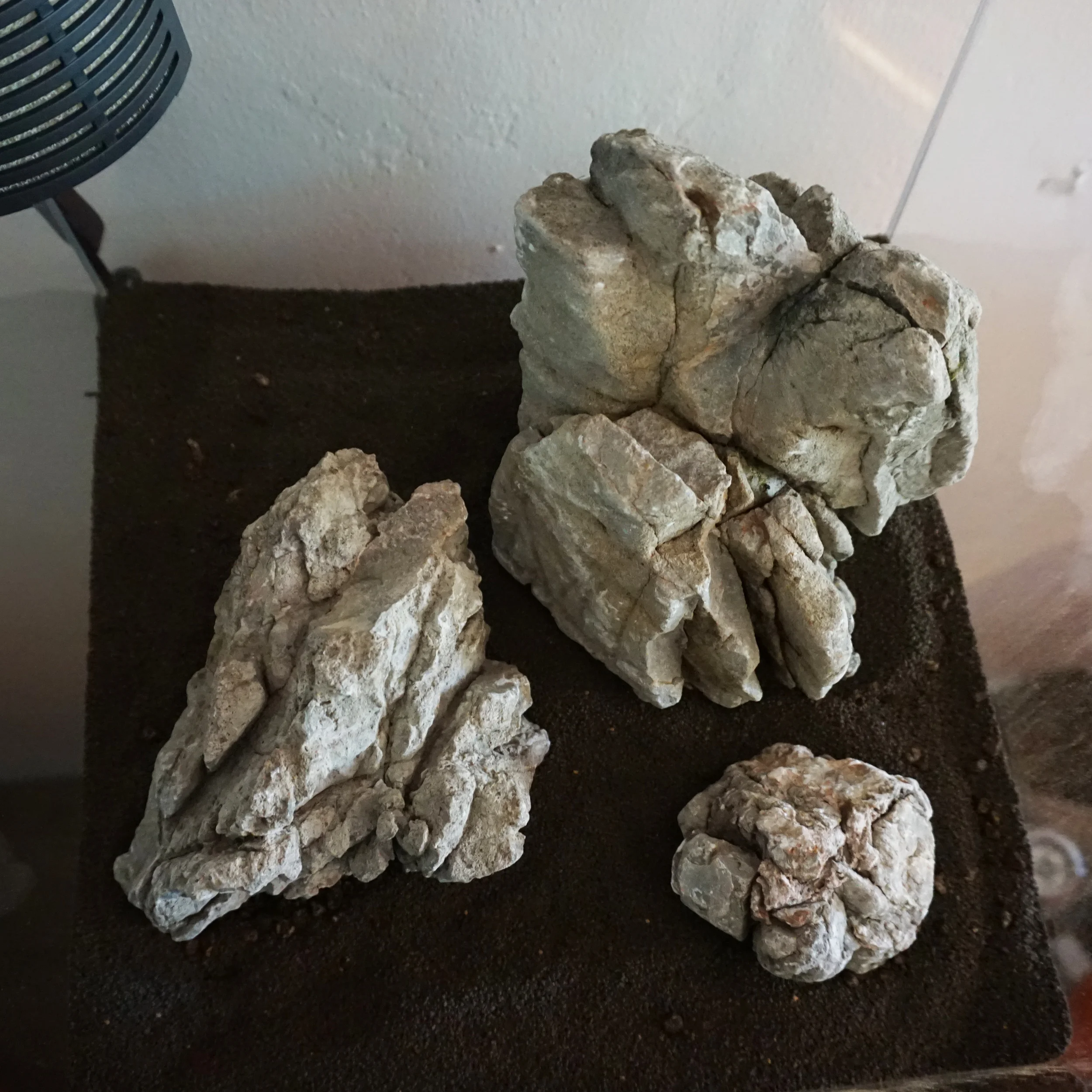 Once your design is finalized, you can now take more substrate and add it to the tank. You may want to bring the substrate up higher in one area over another or partially bury a section of rock or wood. In other words, create a three dimensional space. When you are done, you will want about 2.5" to 3" of coverage throughout. Some areas can have slightly more, and some less depending on the overall design. Do not rush through this part of the set-up. Taking the night to sleep on it will go a long way later when you wish you would have done things differently. It is much easier to make slight changes without water in your aquarium.